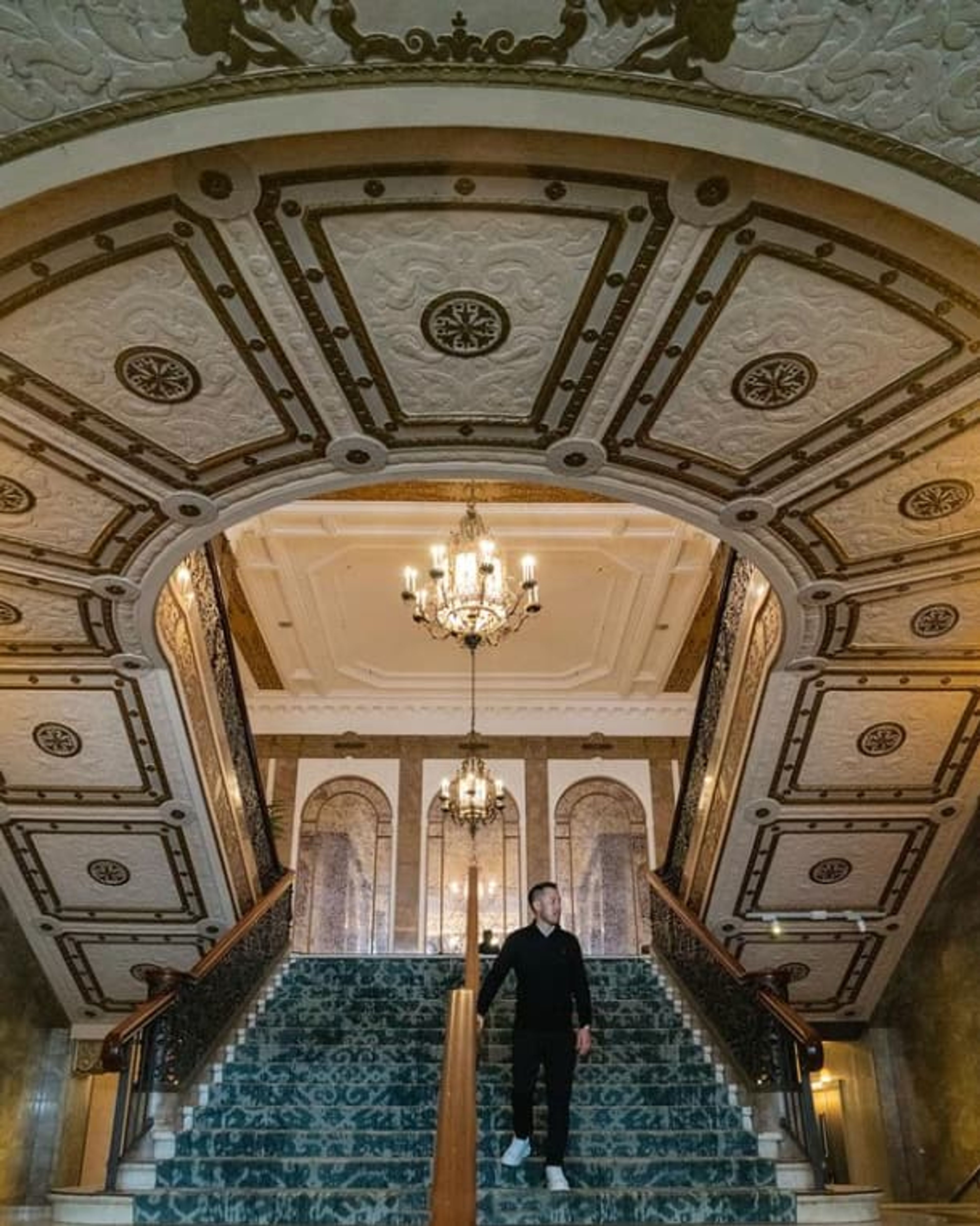 man on grand staircase.