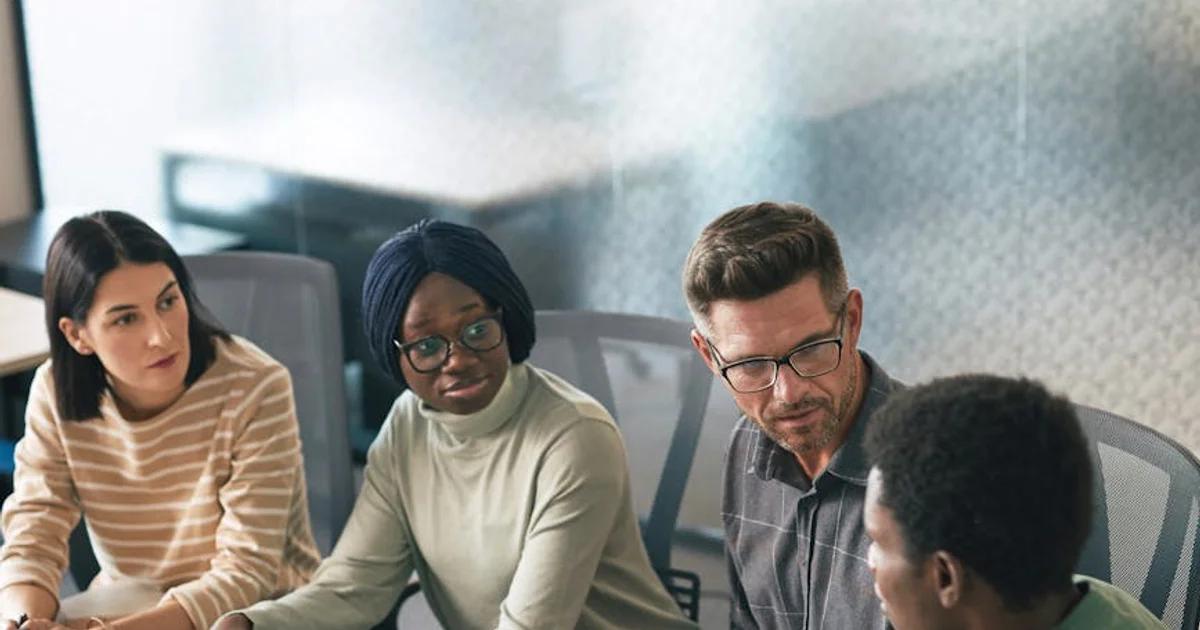 Diverse team collaborating on a digital project, symbolizing effective Cross-Departmental Accessibility Collaboration.