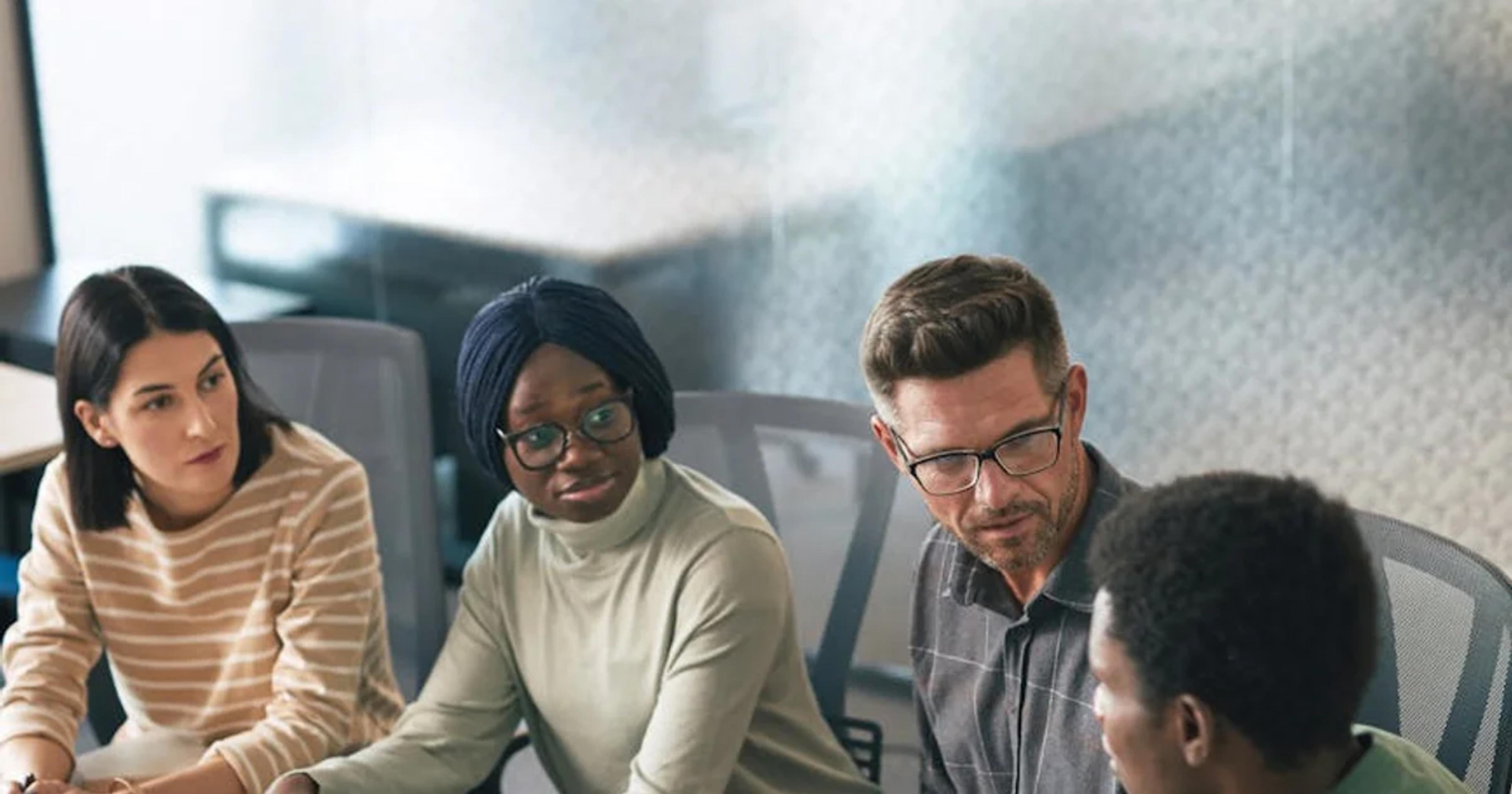 Diverse team collaborating on a digital project, symbolizing effective Cross-Departmental Accessibility Collaboration.