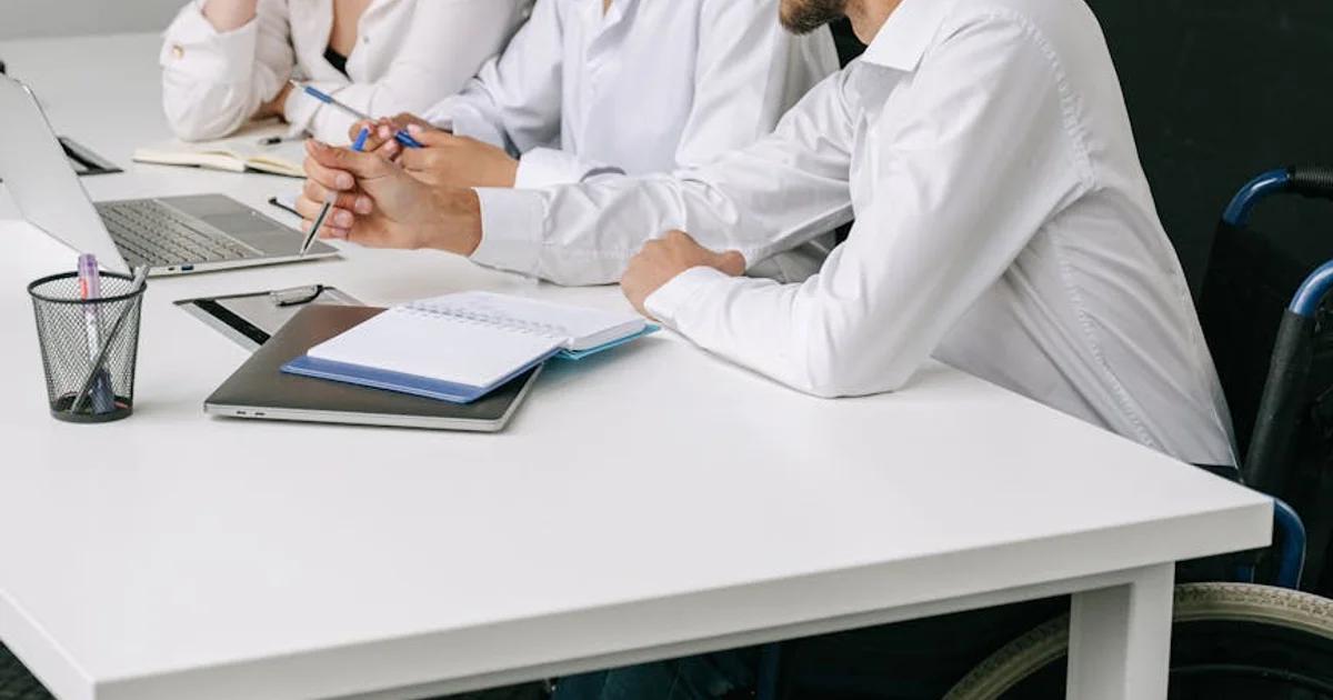 Small business owner in a wheelchair using a laptop, highlighting ADA awareness and digital accessibility.