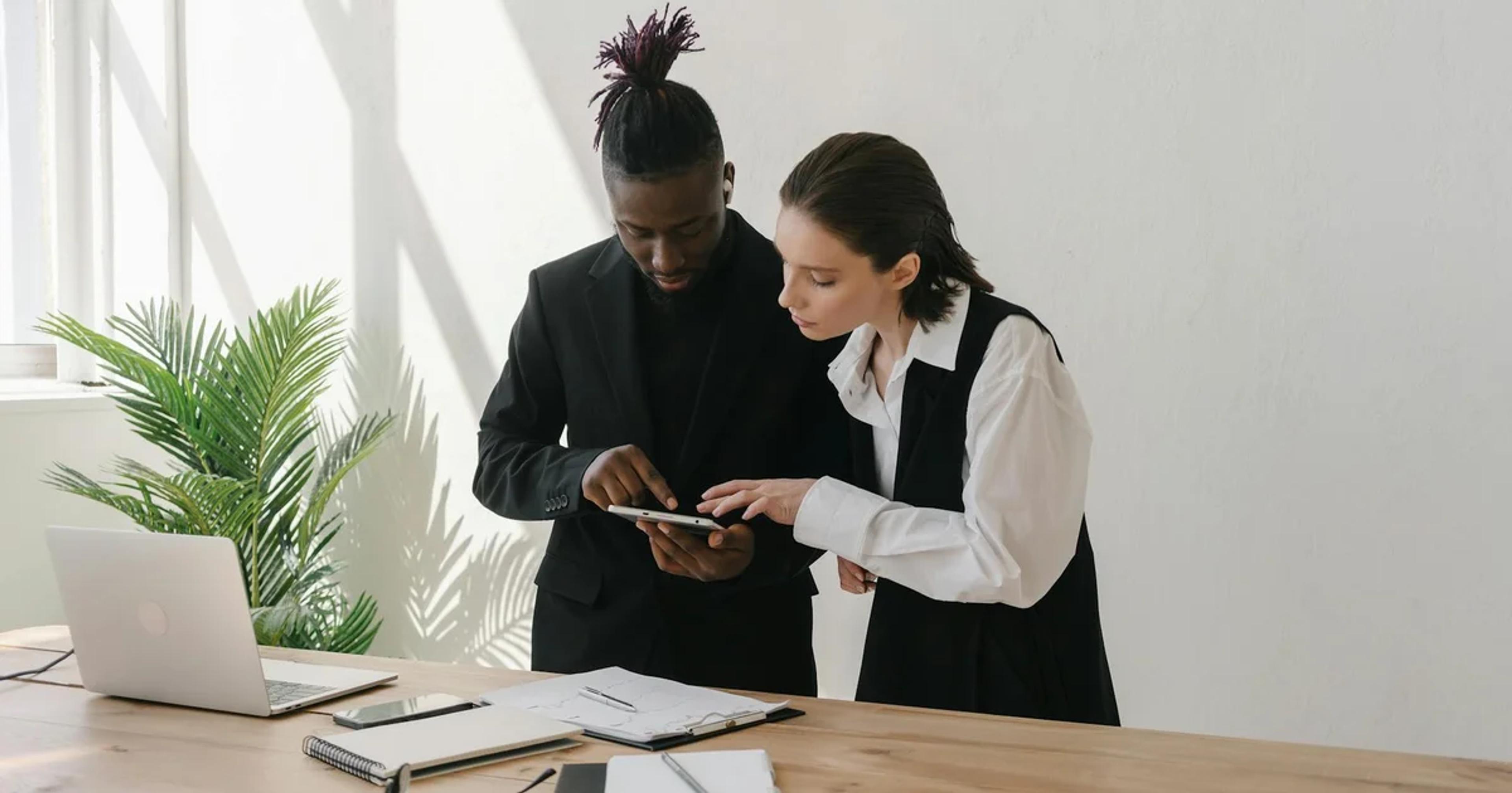 Government officials collaboratively examining digital accessibility standards on a tablet screen, symbolizing inclusive GovTech procurement.