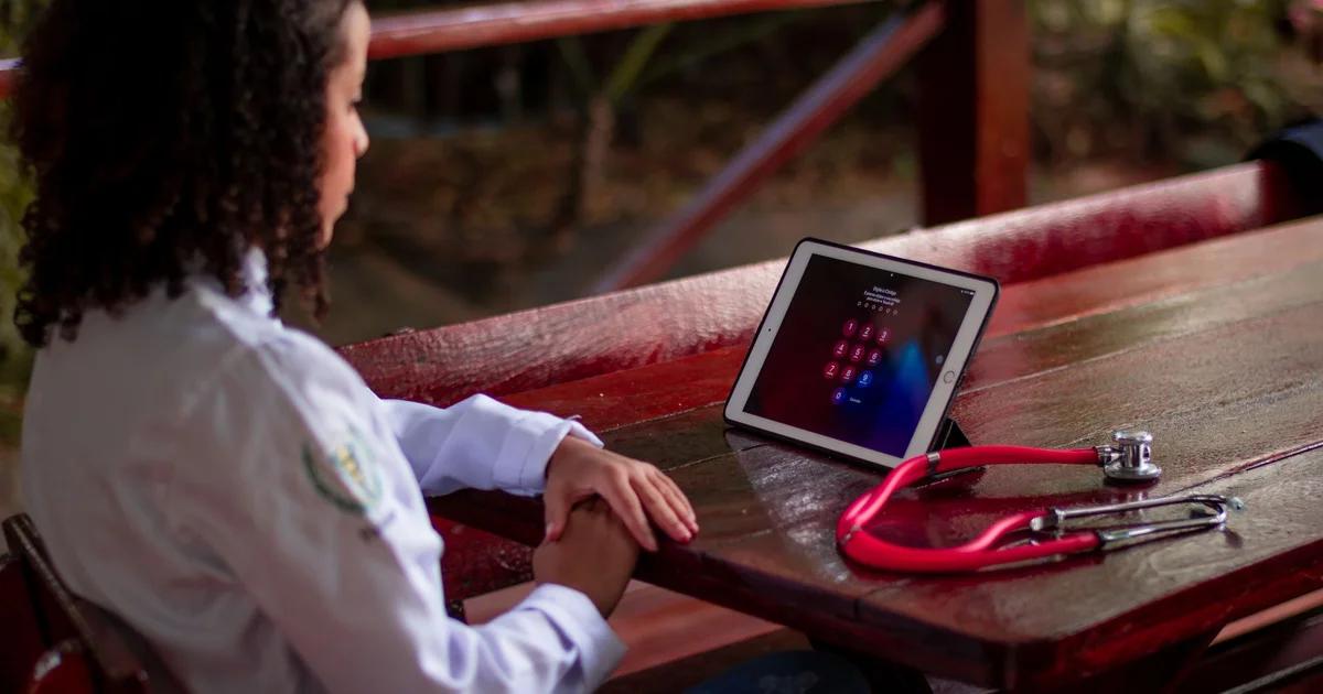 A professional using a screen reader on a device for accessible ADA compliance in civic telehealth