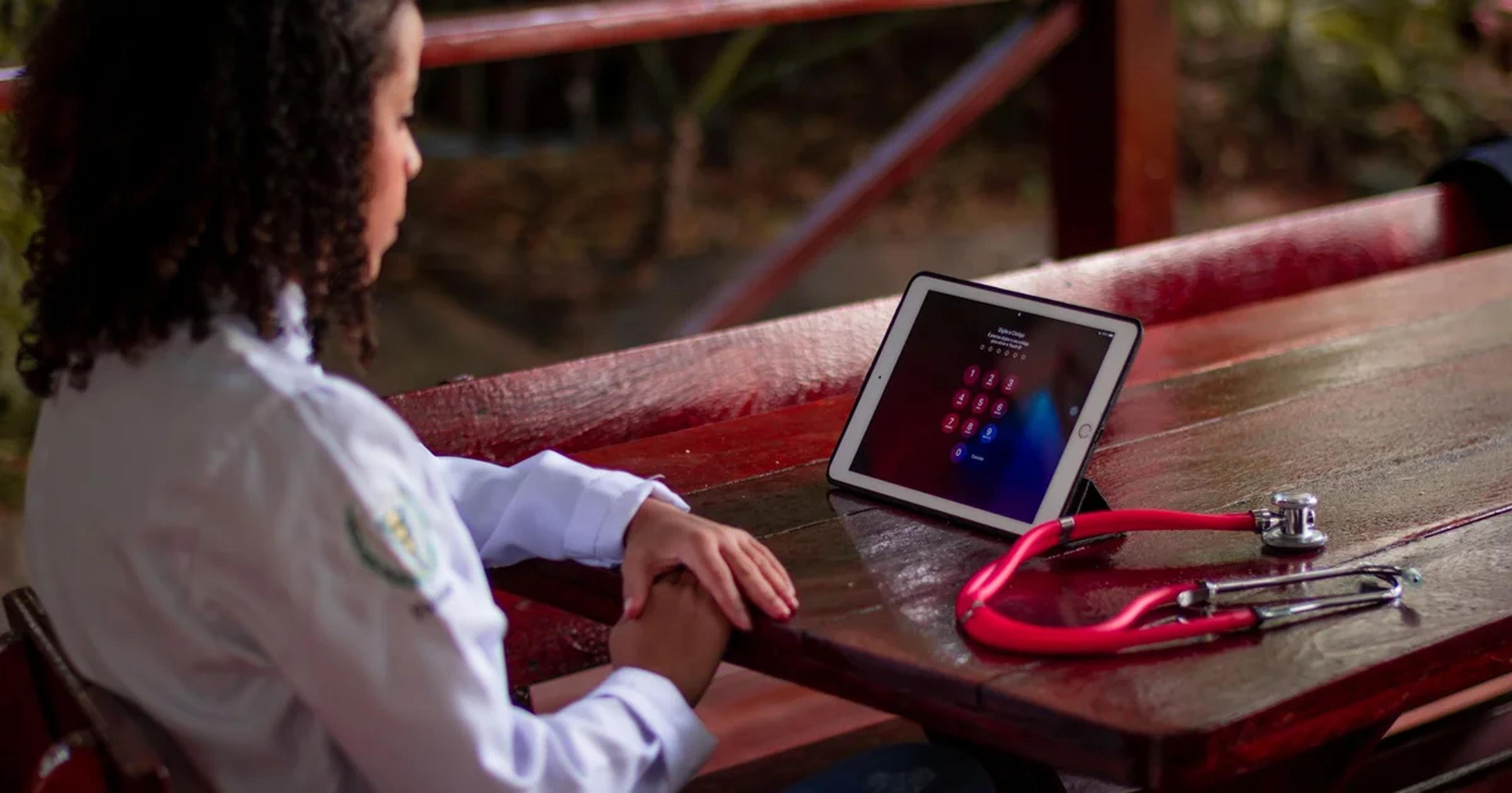 A professional using a screen reader on a device for accessible ADA compliance in civic telehealth