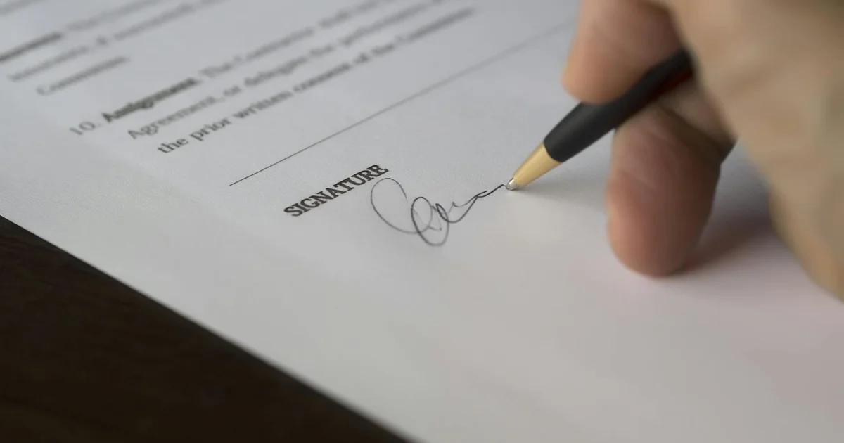 Professional reviewing a legal contract regarding vendor liability and compliance