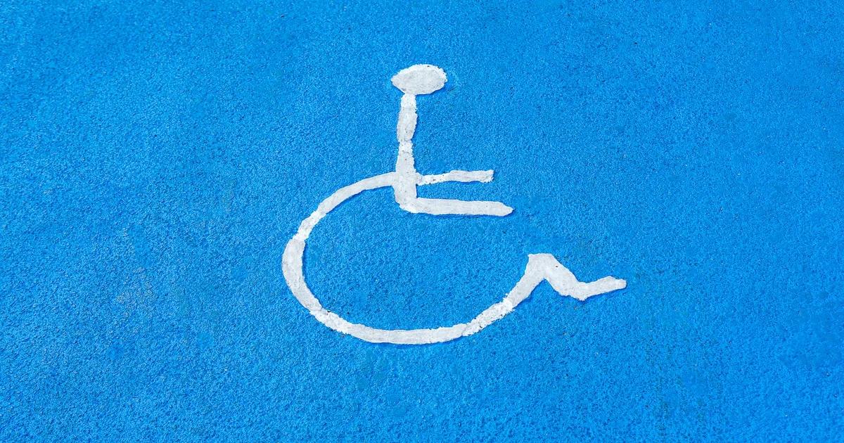Diverse team reviewing evolving ADA Web Accessibility guidelines on a laptop, ensuring digital compliance.