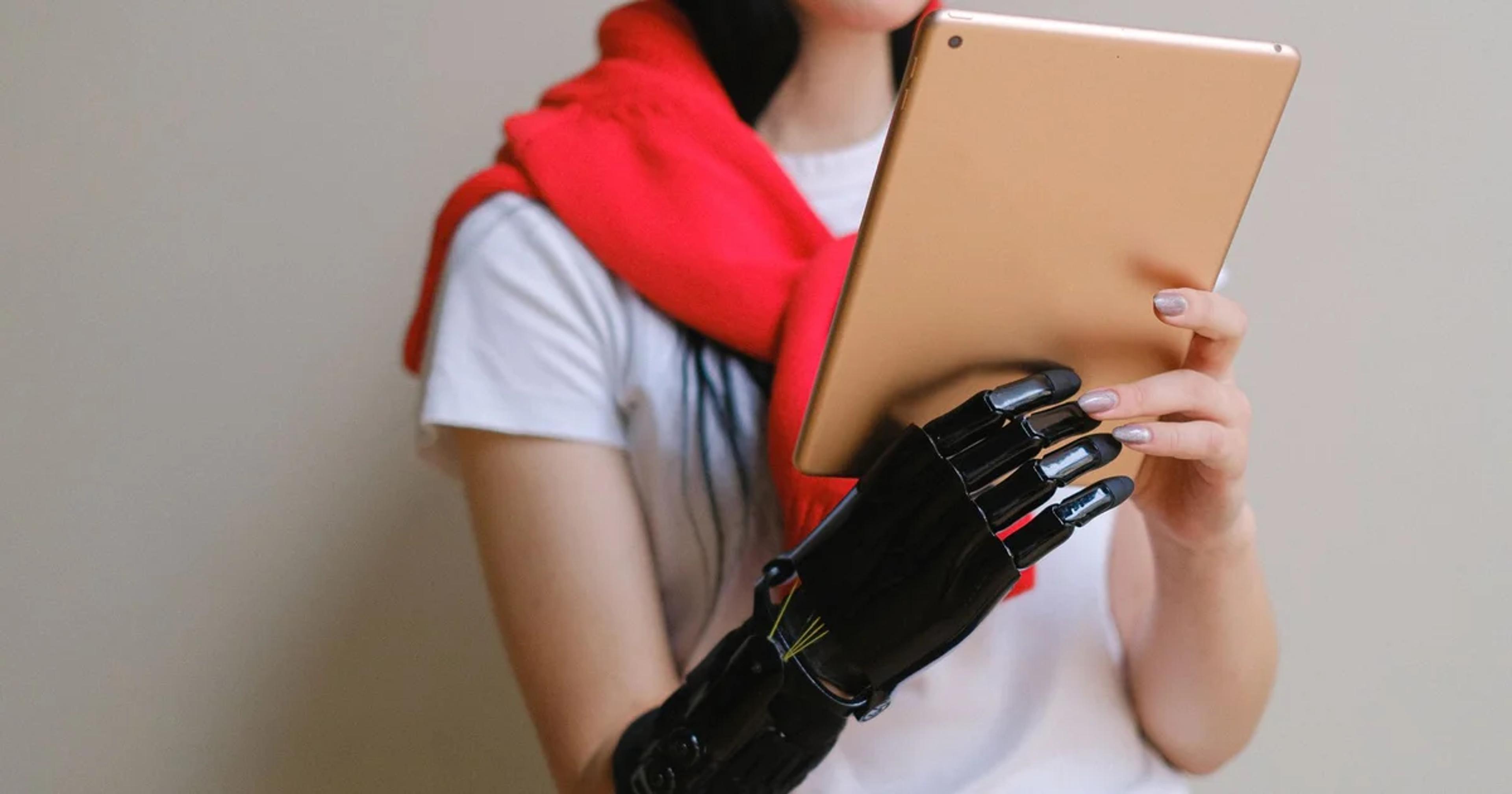 A person using an accessible civic telehealth portal on a laptop with assistive technology