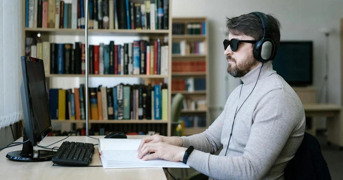 Blind student using a laptop with a screen reader, demonstrating empowering blind student learning.
