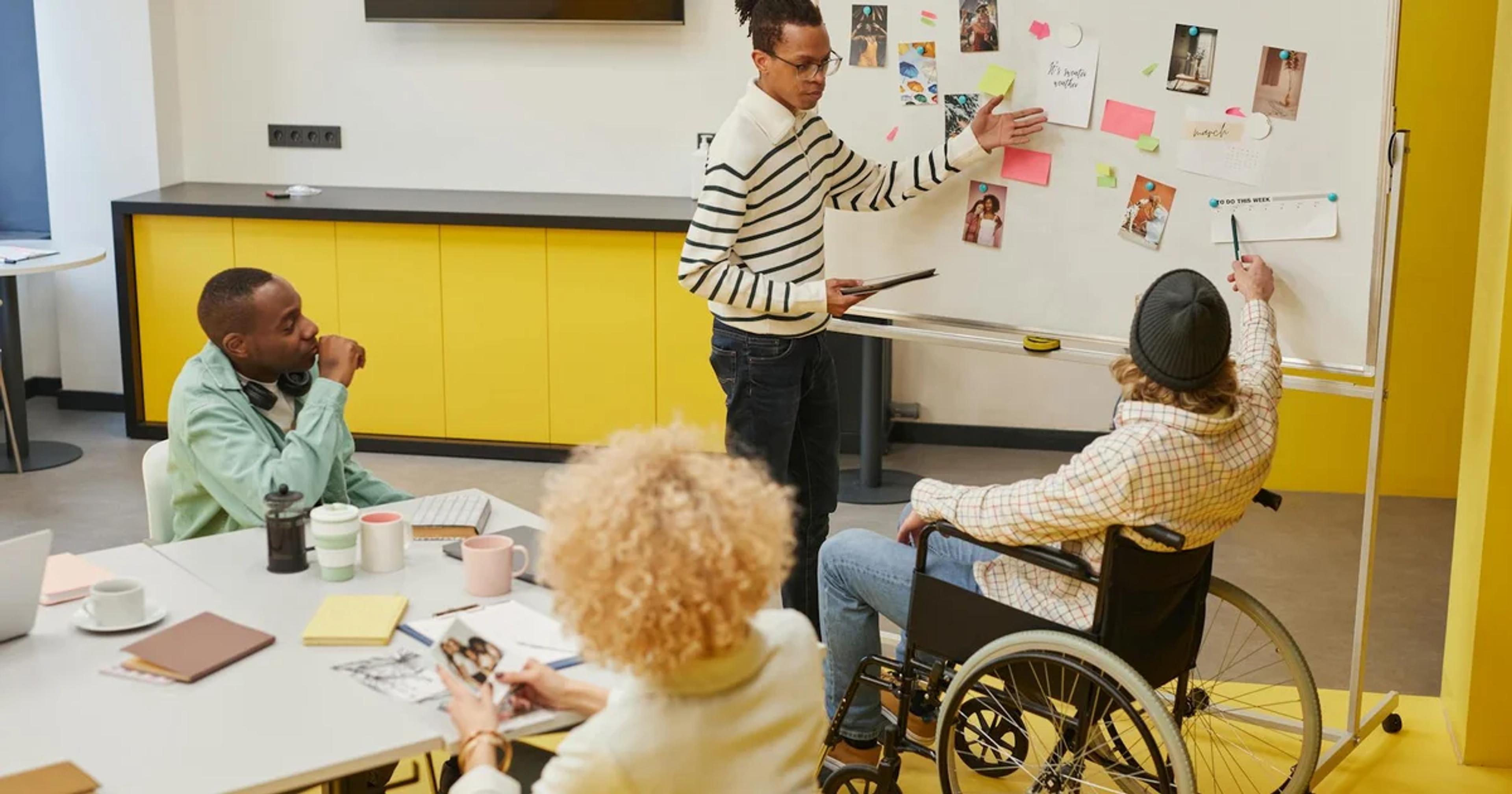 Diverse team collaborating on a screen, symbolizing adaptive accessibility skill development for digital inclusion.