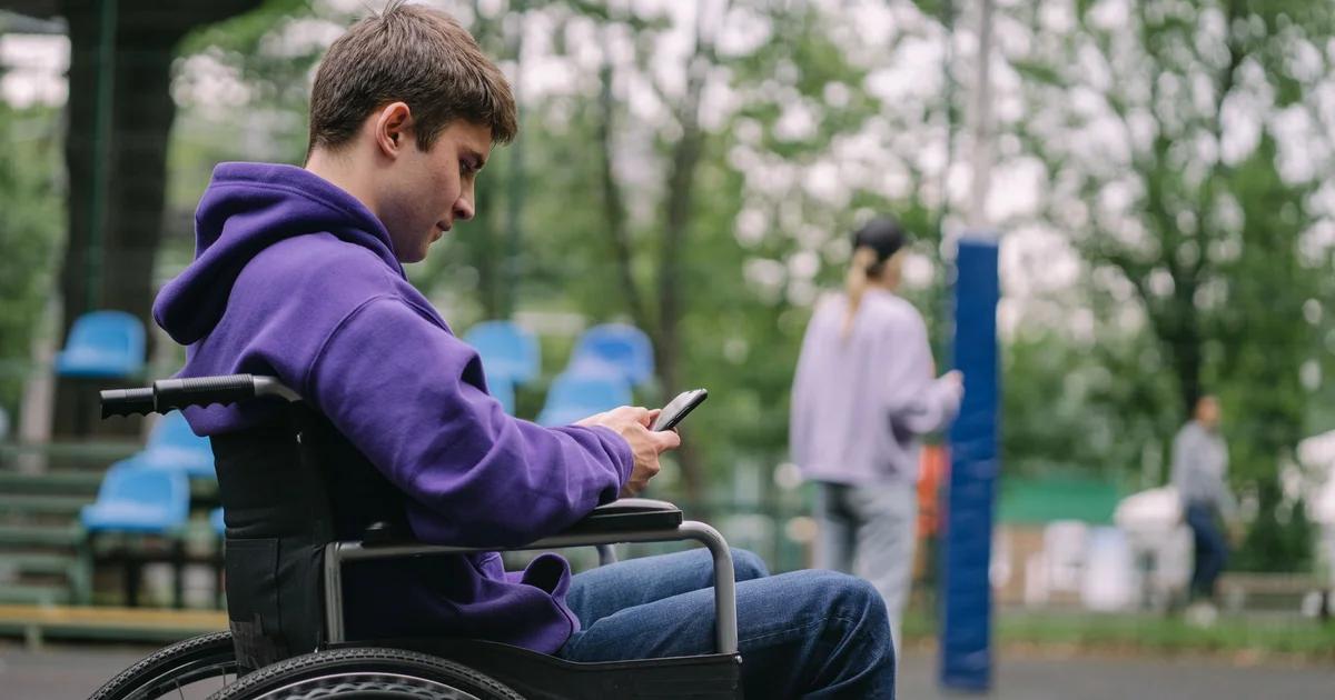 A person using a smartphone to view ADA compliant civic notifications and digital alerts