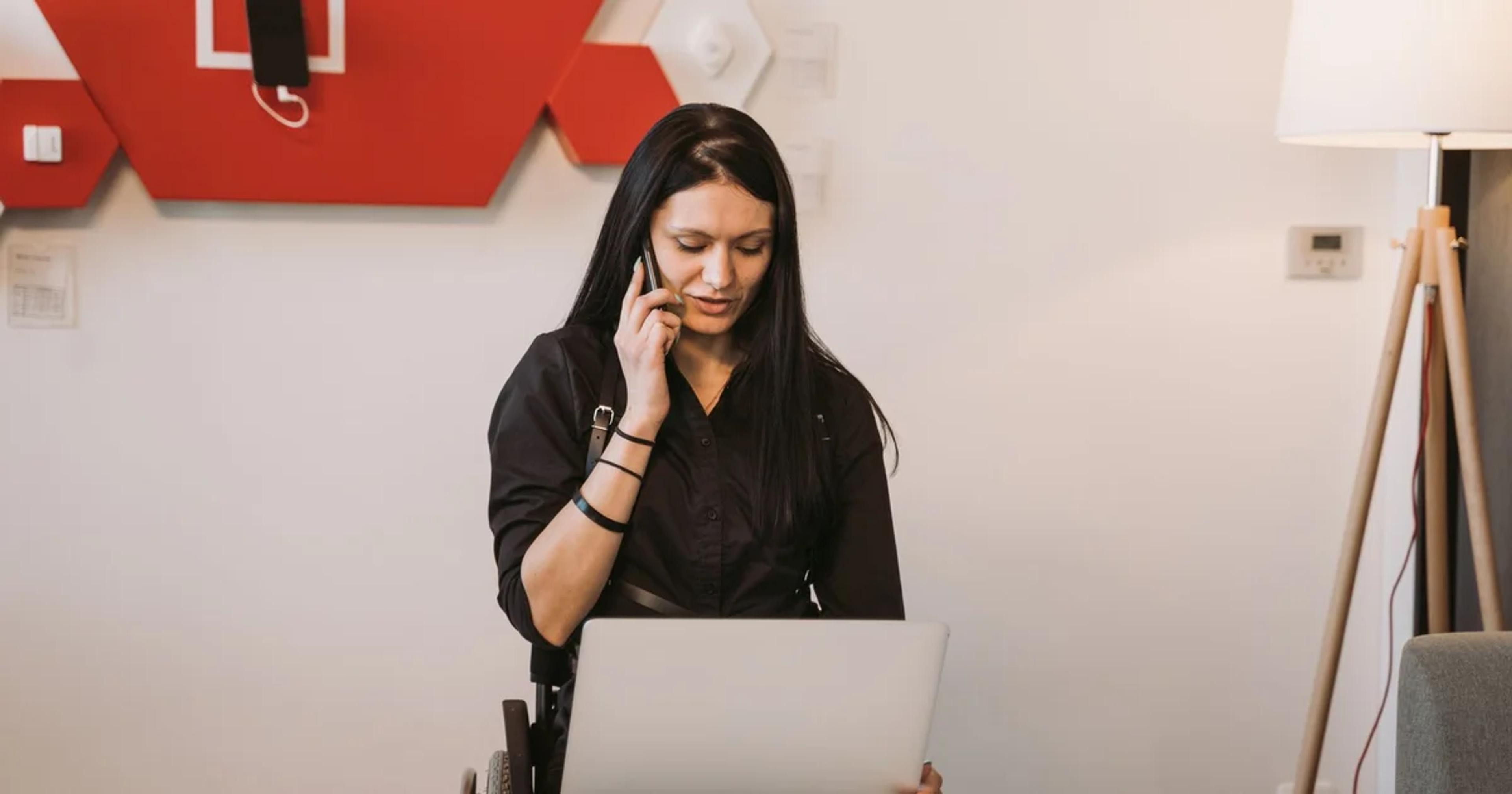 A professional reviewing disability-inclusive digital procurement documents on a laptop