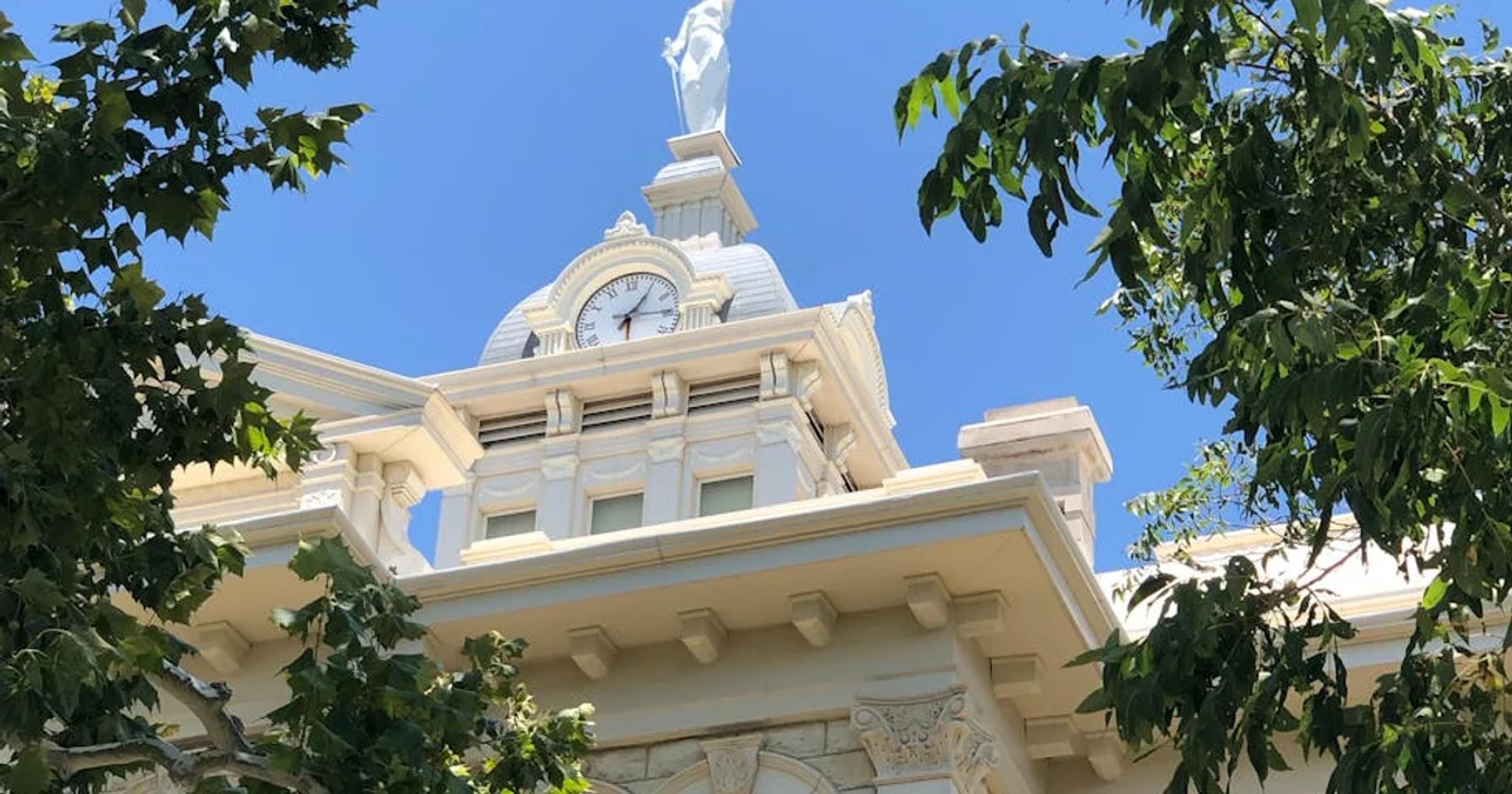 Government official reviewing legal documents and a ticking clock, emphasizing dual deadline compliance risk.