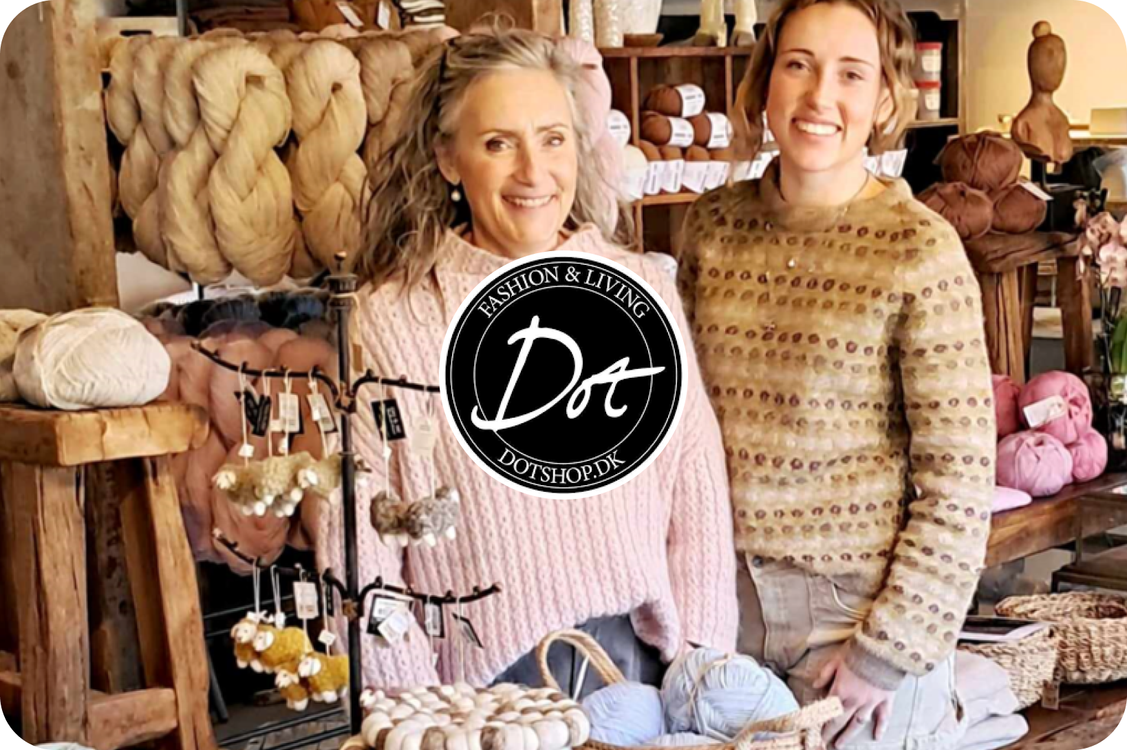 Logo "Fashion & Living Dot DOTSHOP.DK" overlaying an image of two smiling women in a yarn and craft shop.