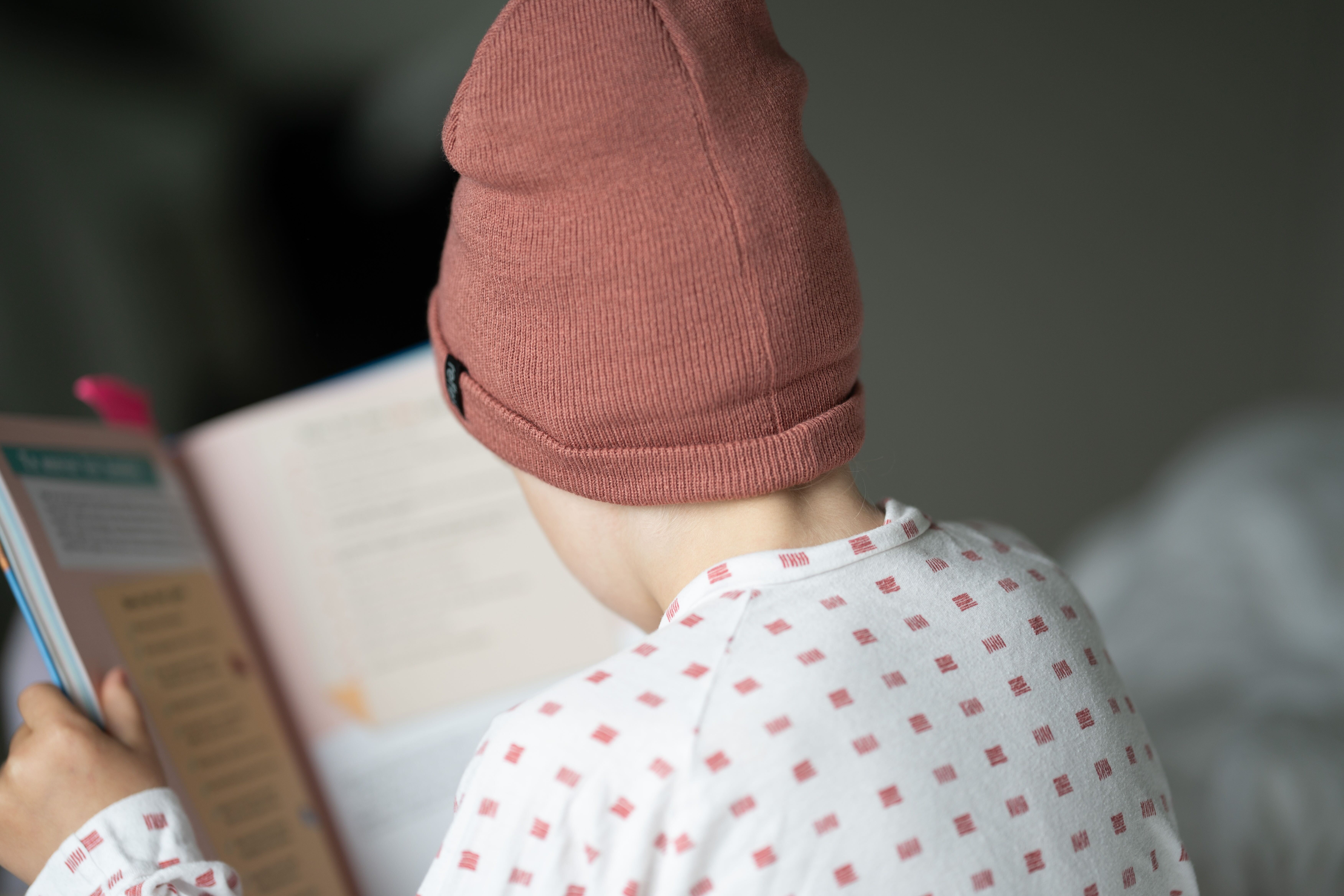 Four men on a wooden pier, enveloped in steam, as they enter or prepare to enter cold water.