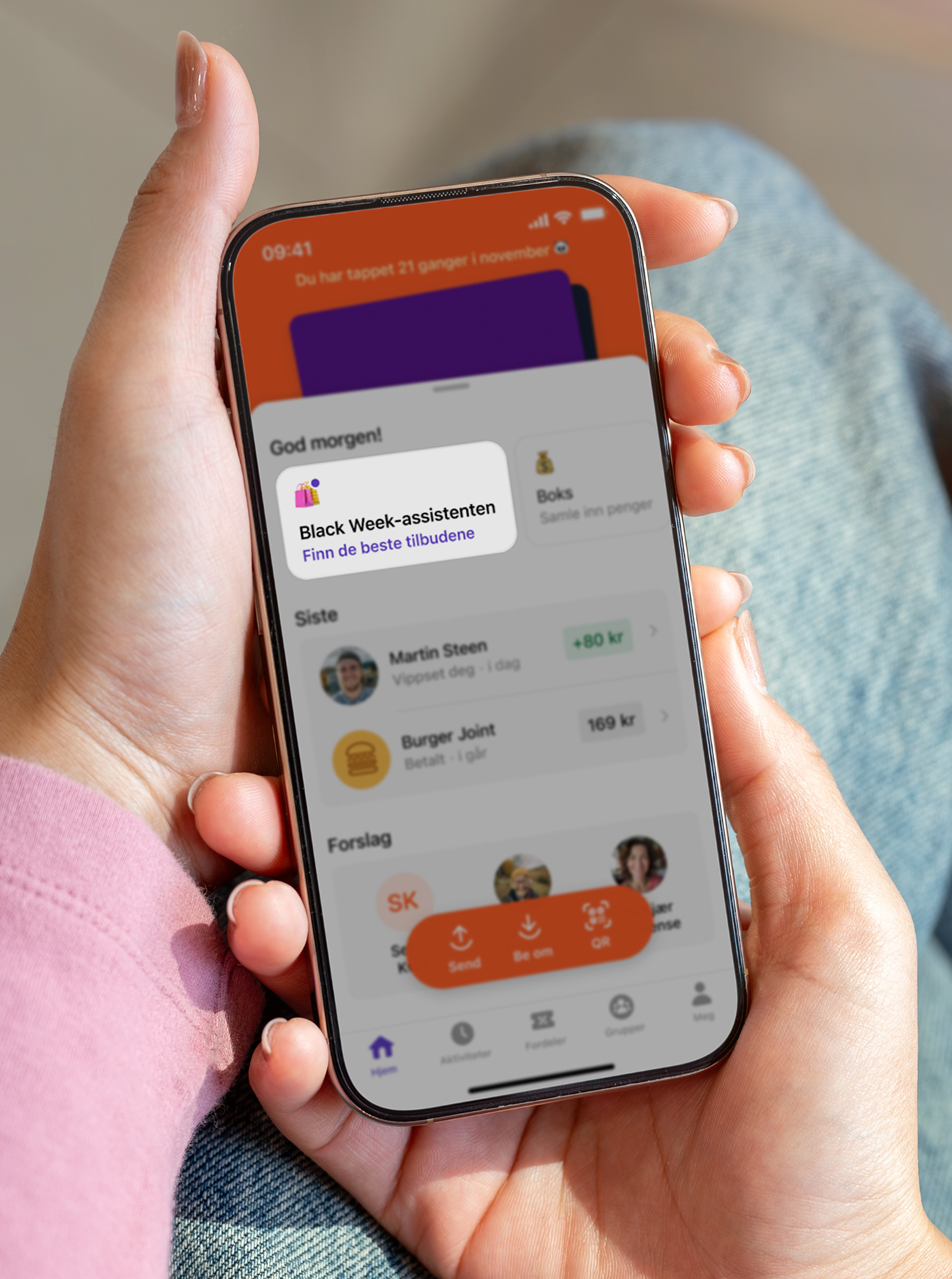 A person holds a smartphone displaying a banking app with a "Black Week Assistant" pop-up.