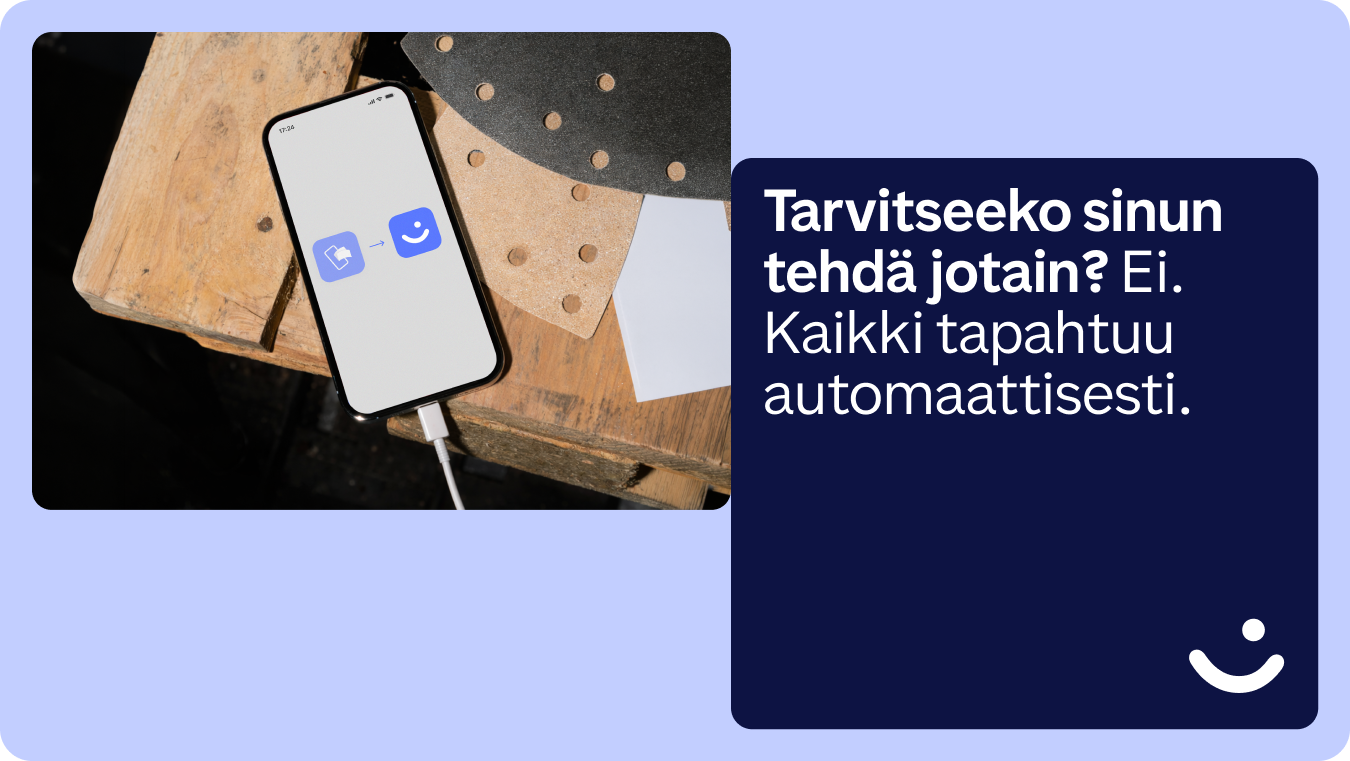A smartphone on a wooden surface displays a note icon transforming into a smiley face. Beside it, Finnish text states: "Do you need to do anything? No. Everything happens automatically."