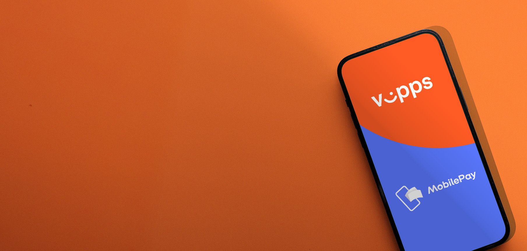 a smart phone is sitting on top of an orange table .