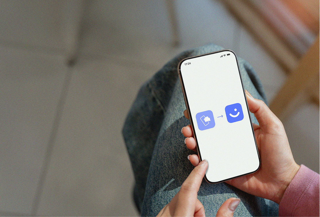 A hand holds a smartphone displaying a document icon transforming into a smiling face icon.