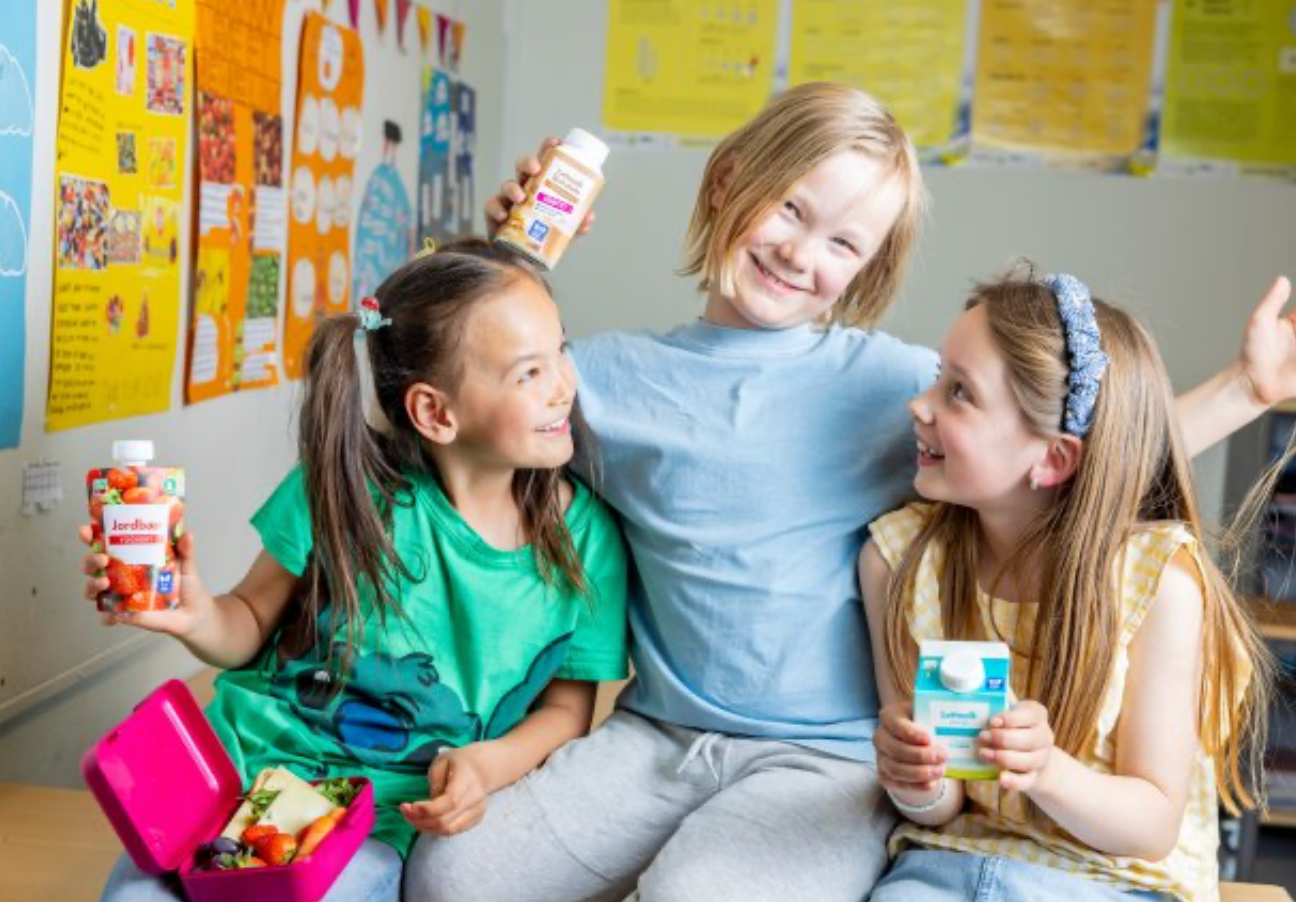 a girl holding a bottle that says ' jordbær ' on it