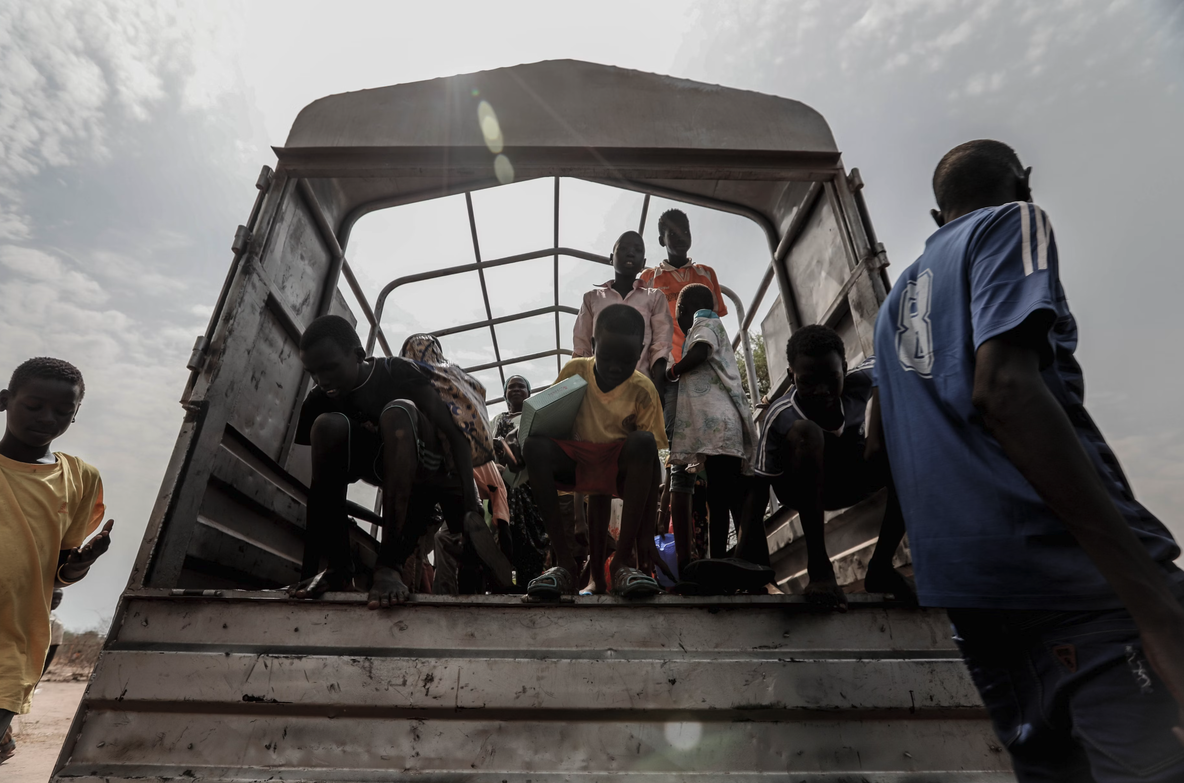 An image of kids getting off of a truck