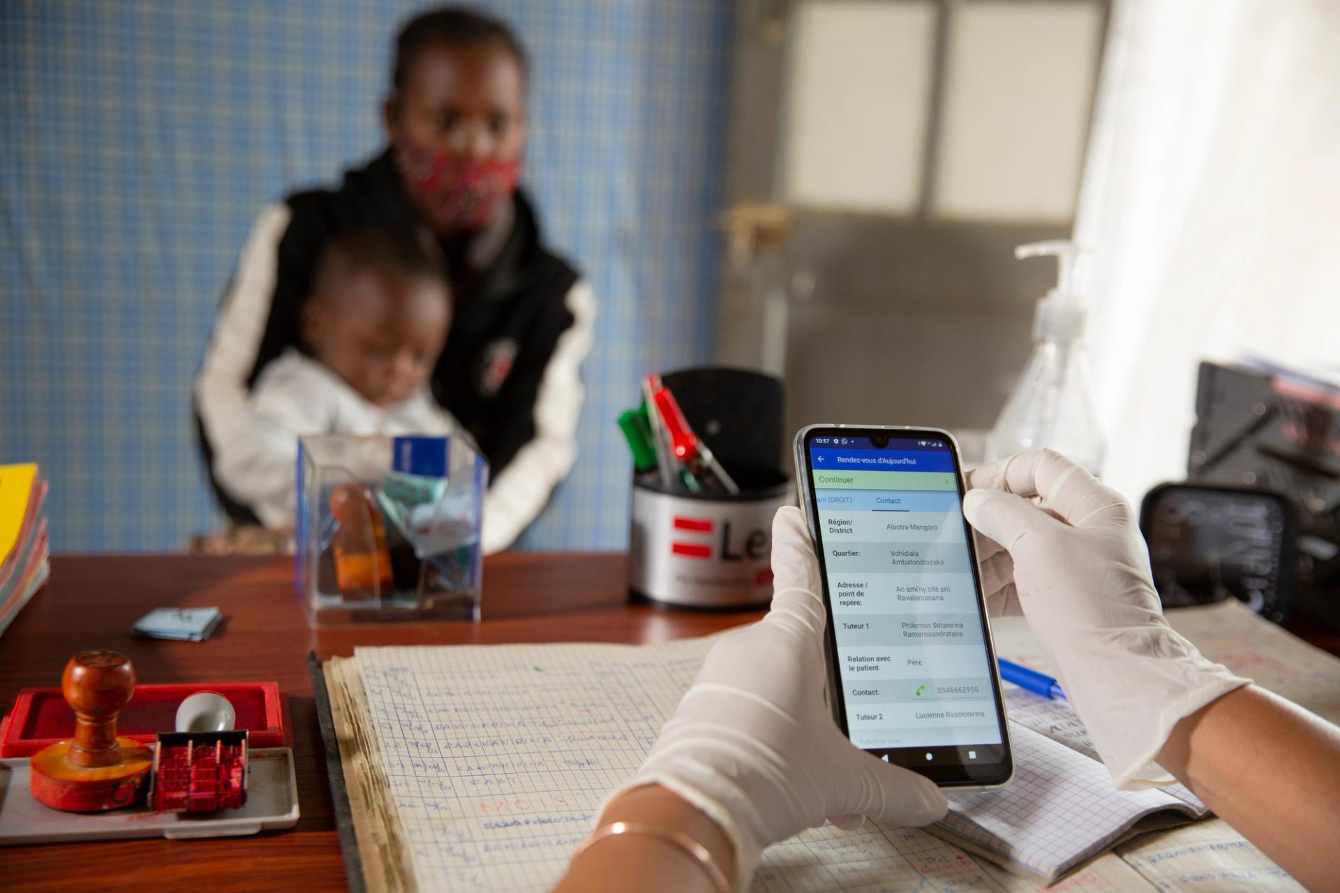 A healthcare worker capturing details in CommCare. Data that will feed through OpenFn.