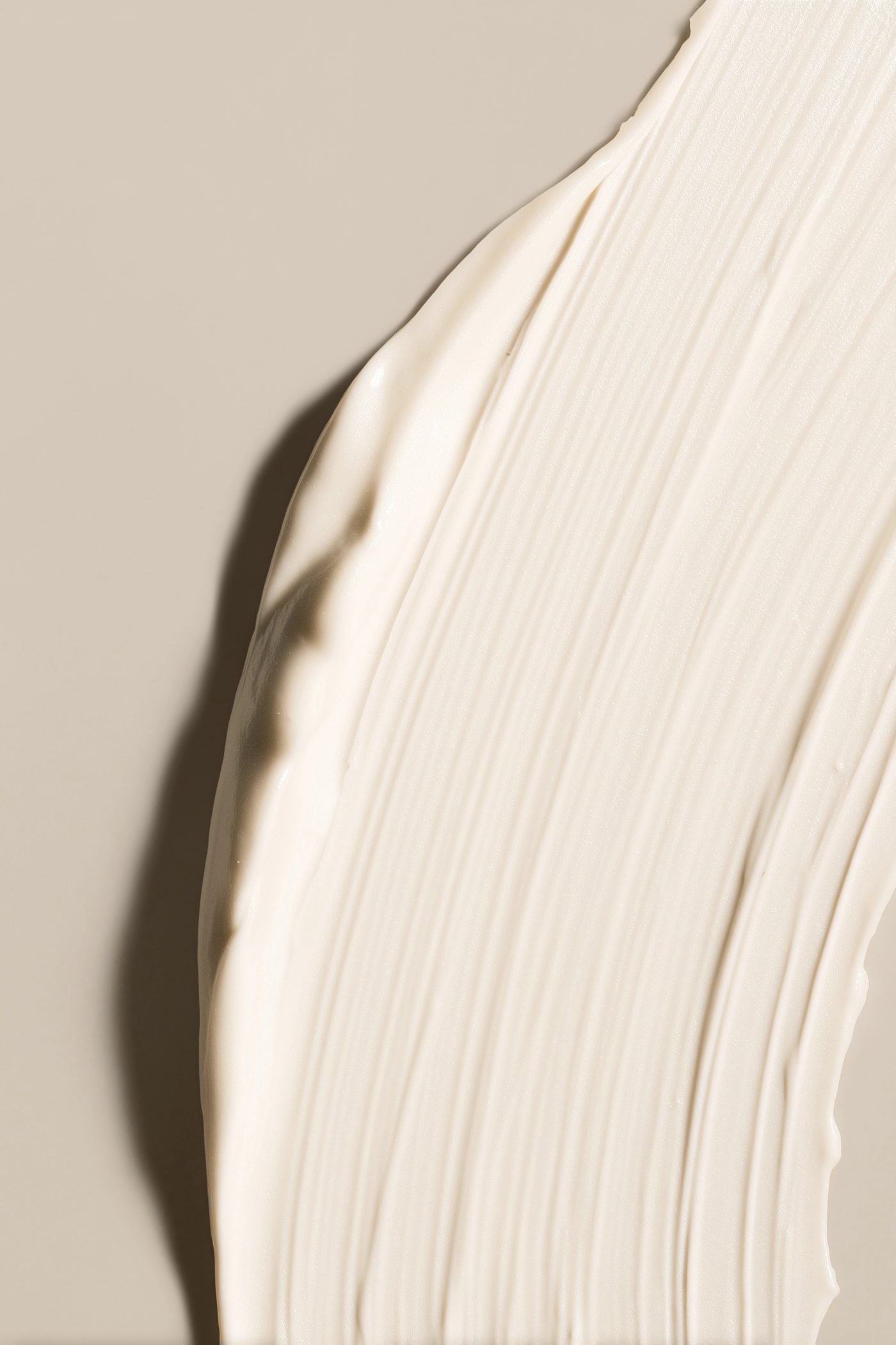 A close study of a pale cream stroke with fine ridges and shadow.