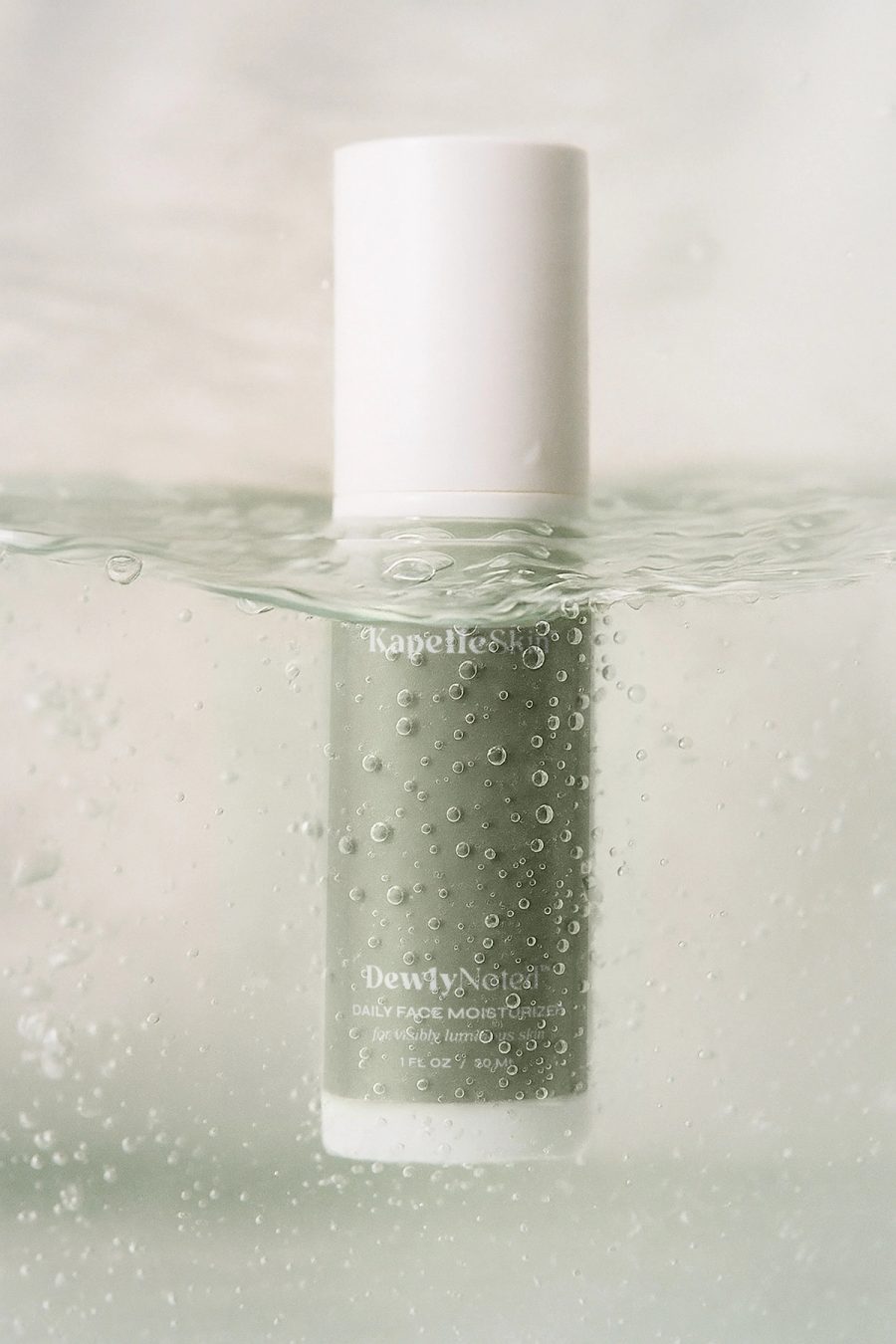 KapelleSkin moisturizer seen through bubbles and water.