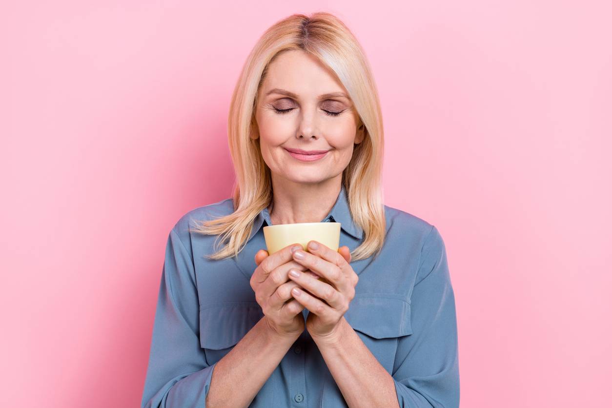 Woman looking happy, holding mug