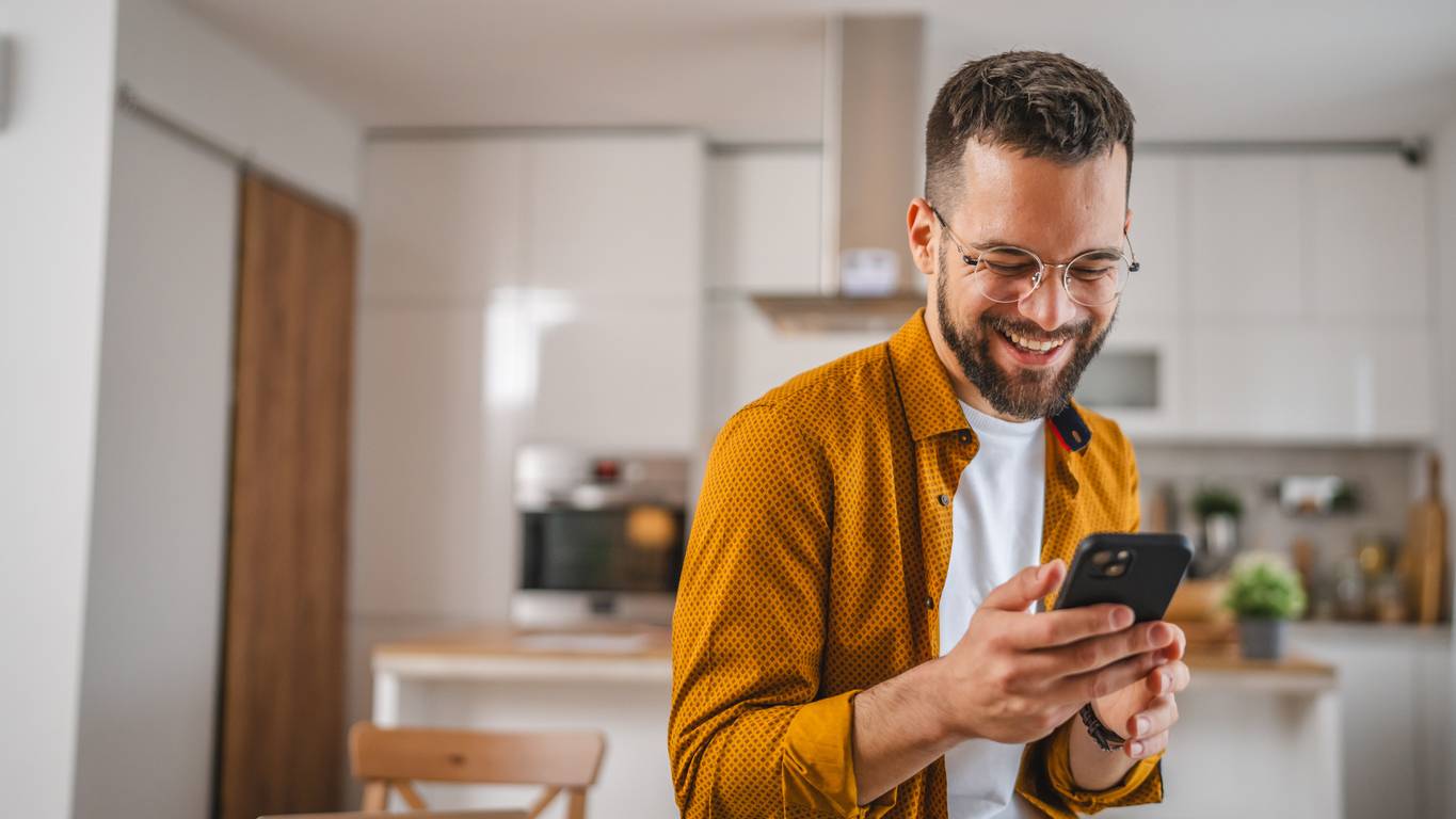 Happy man looking at phone