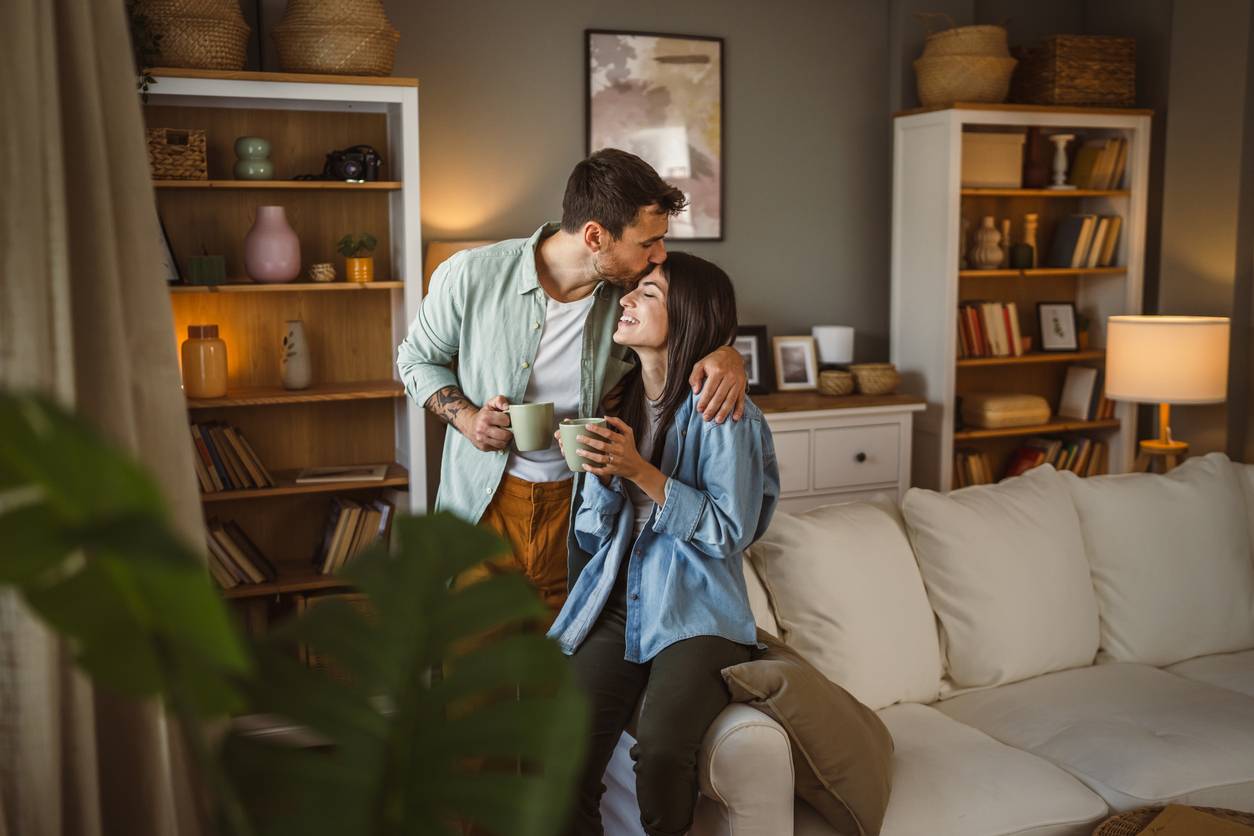 Man kissing wife on forehead