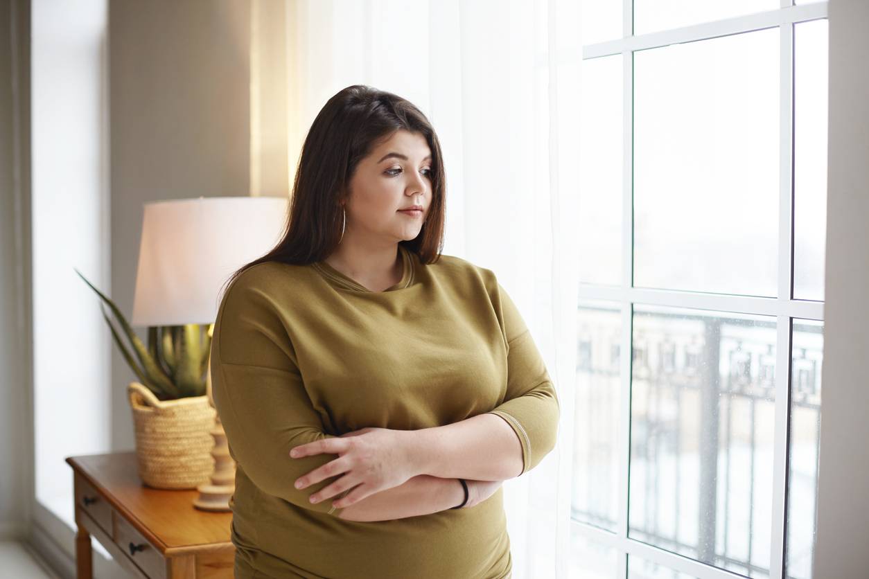 Overweight woman looking worried