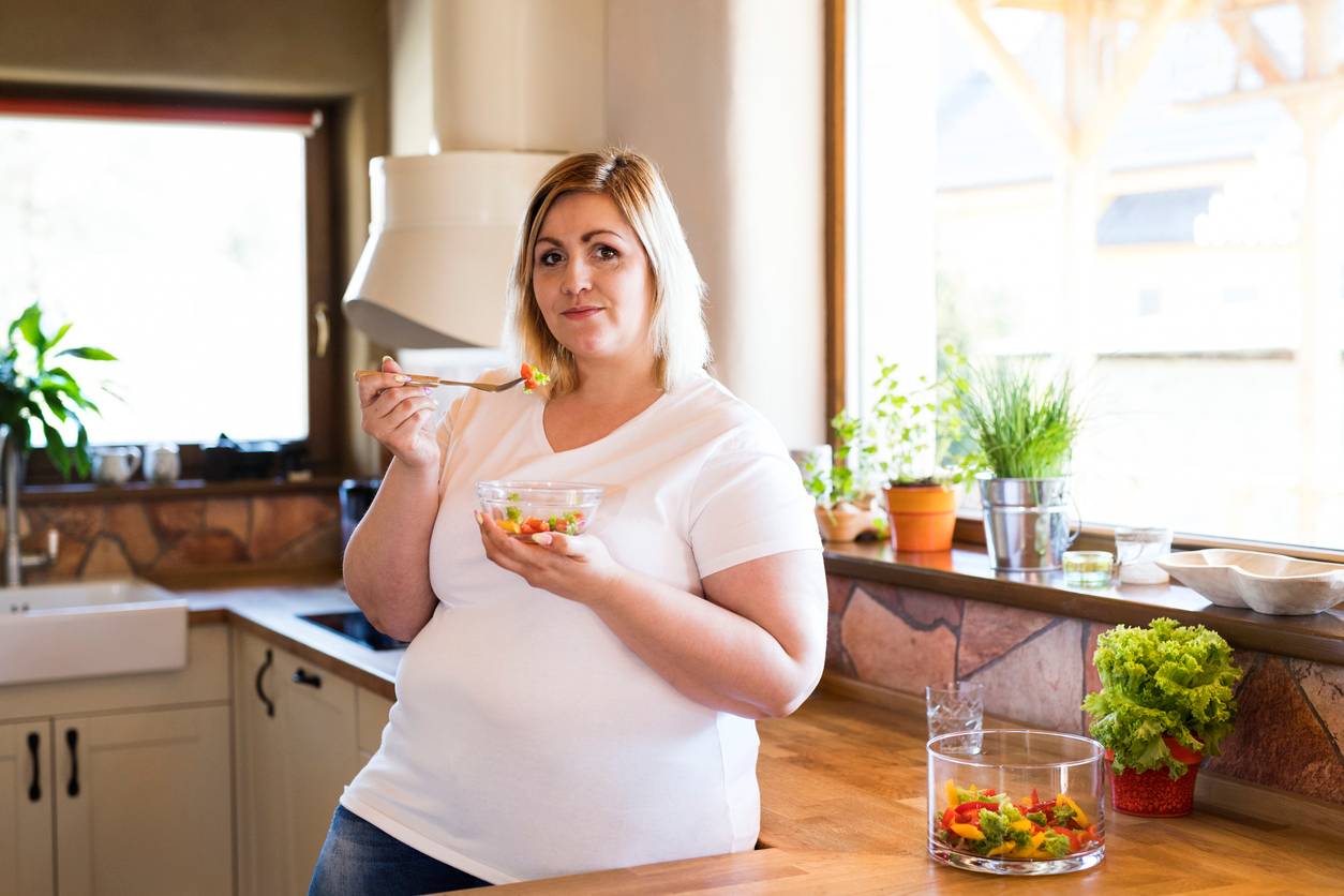 Overweight woman eating healthy food