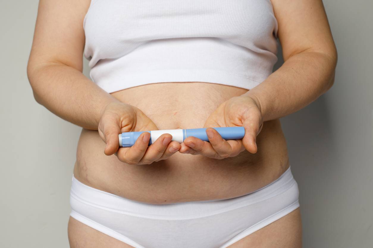 Overweight person measuring stomach