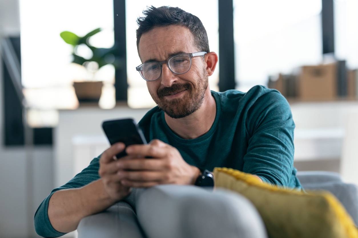 Happy man ordering online using a mobile phone