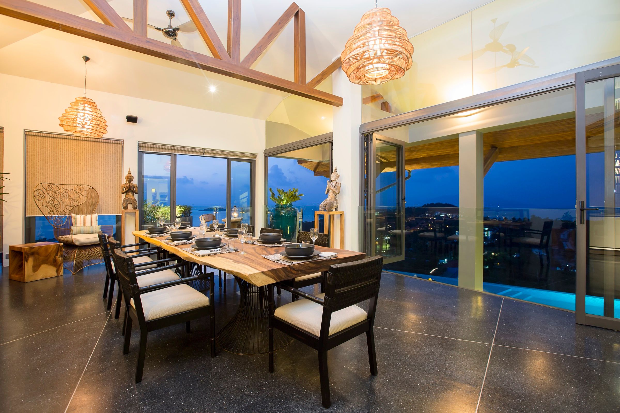 Main dining room set for dinner with an evening sea view