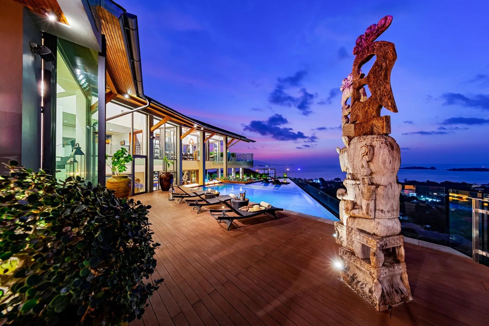 Villa Skyfall infinity pool and carved figure at night