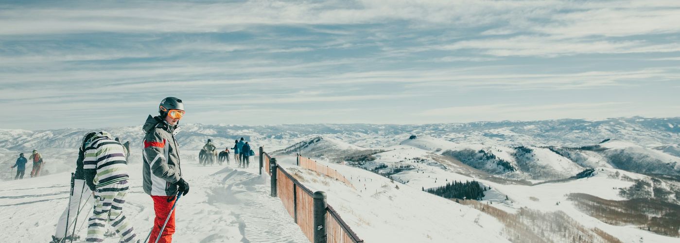 a man standing on top of a snow covered slope