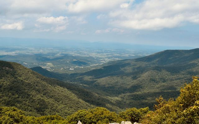 a view of a valley with mountains in the distance