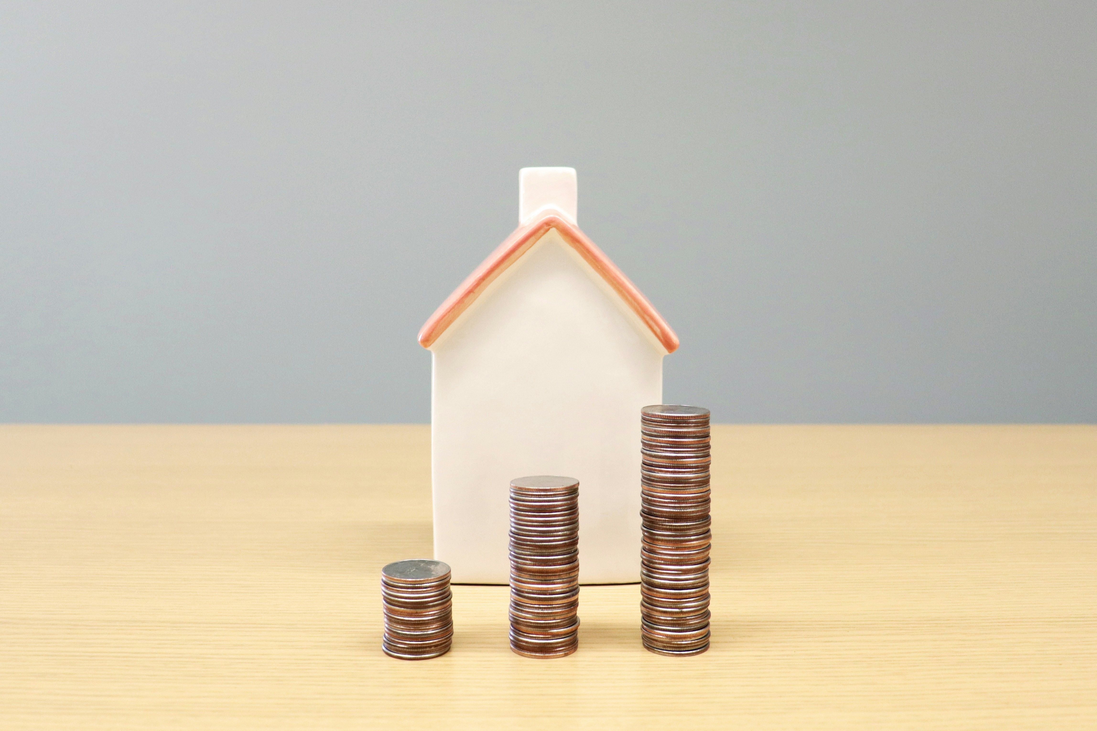 Home with stacked coins in front
