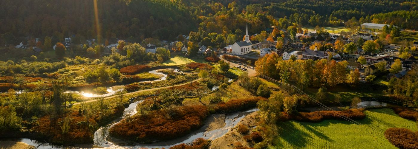 an aerial view of a small town surrounded by mountains