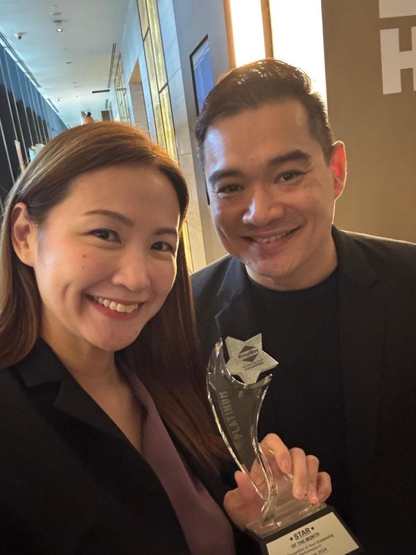 David Ho and Audrie Poh holding an award trophy