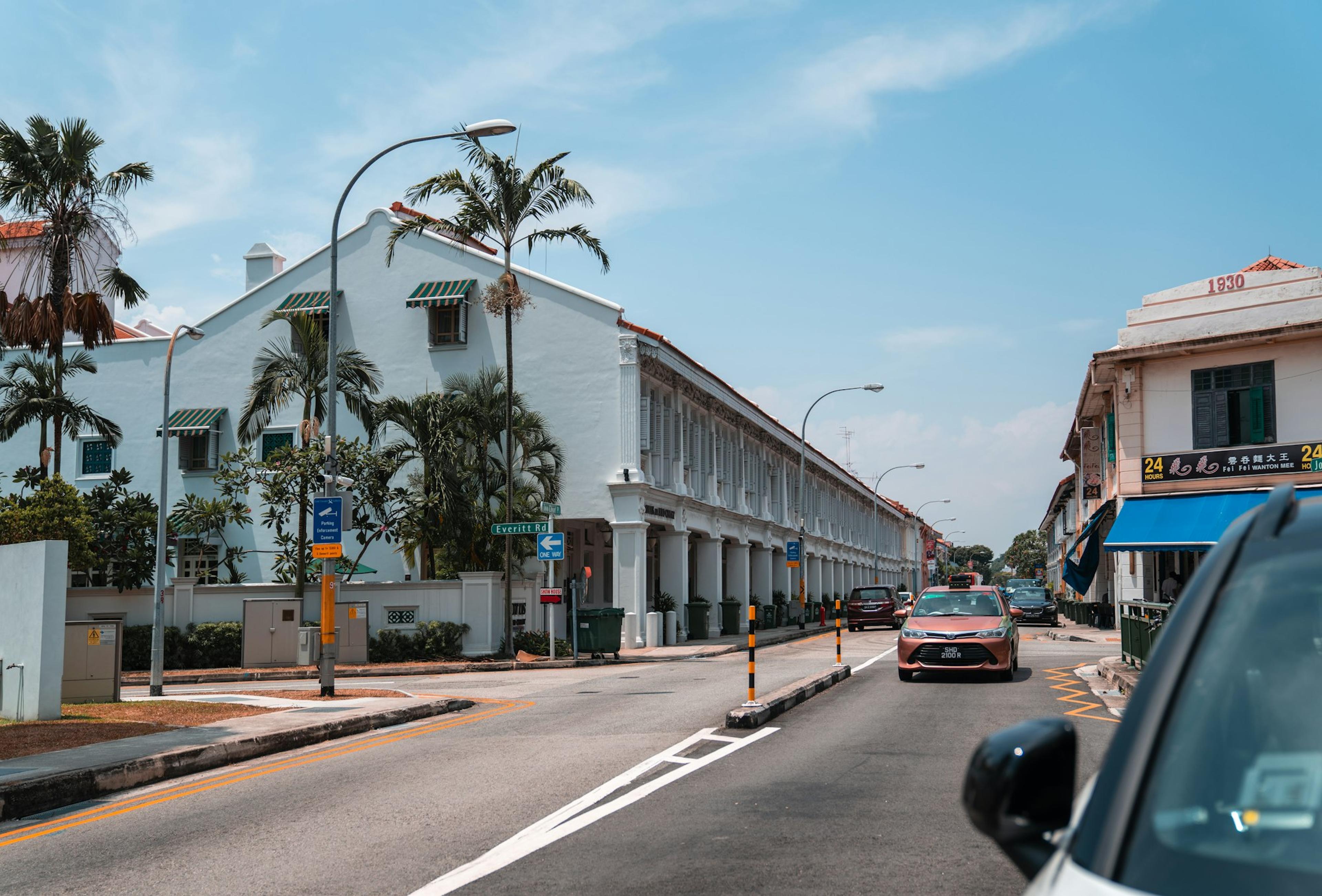 Cars parked on side of road near building during daytime