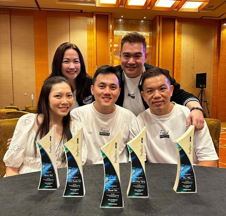 David Ho and Audrie Poh with teammates and their award trophies