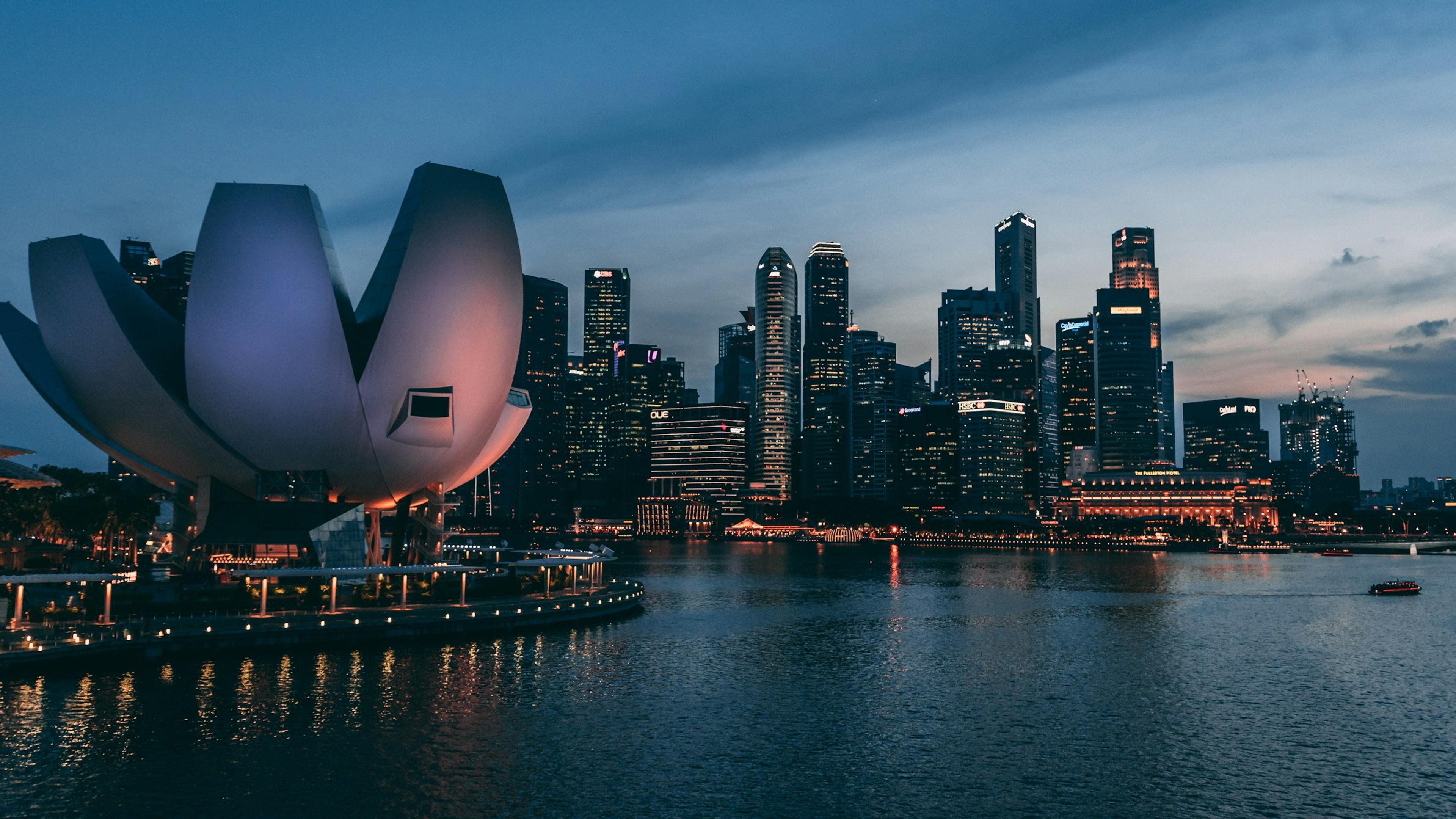 Singapore skyline across Marina Bay at dusk