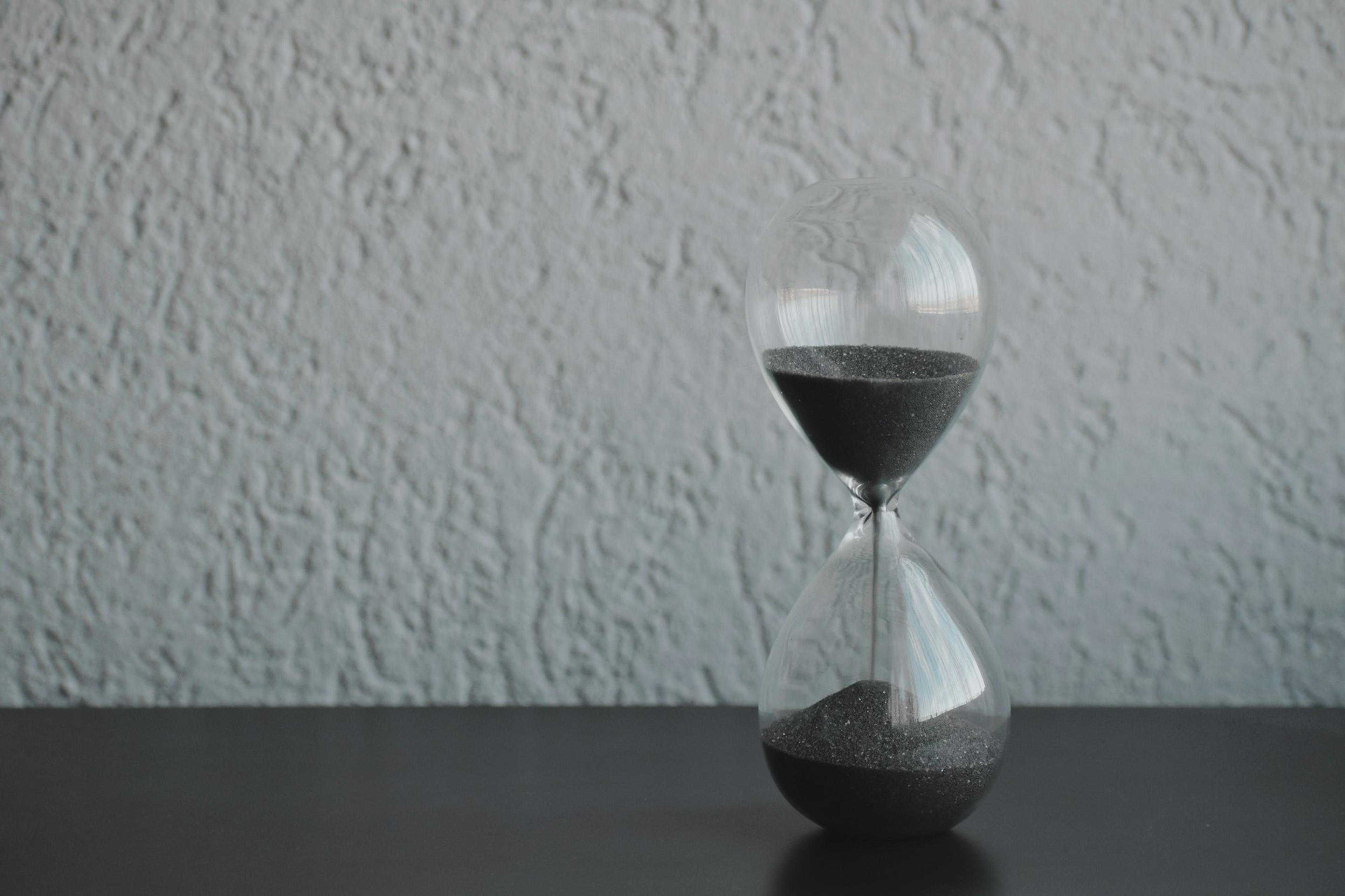 An hourglass with sand running through