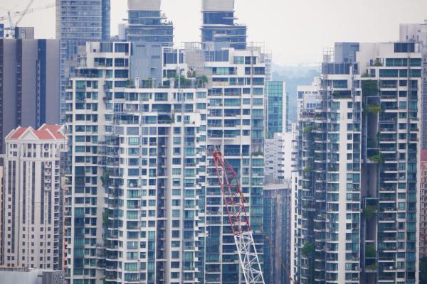 High-rise condominiums in Singapore with a crane over a new development