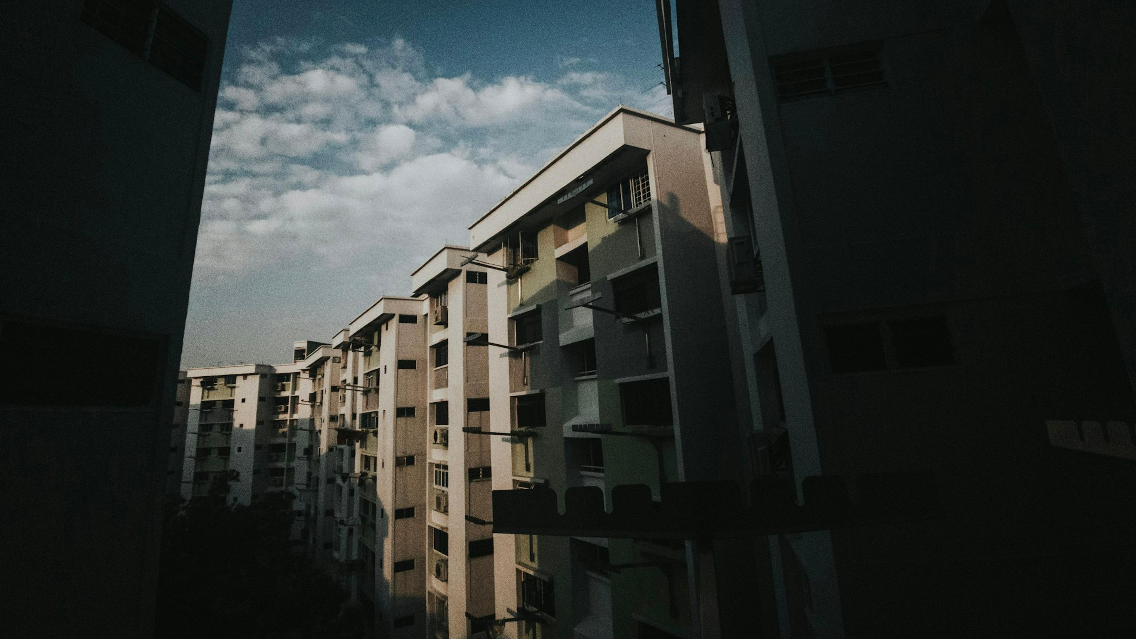 A row of residential blocks seen from a corridor in Tampines