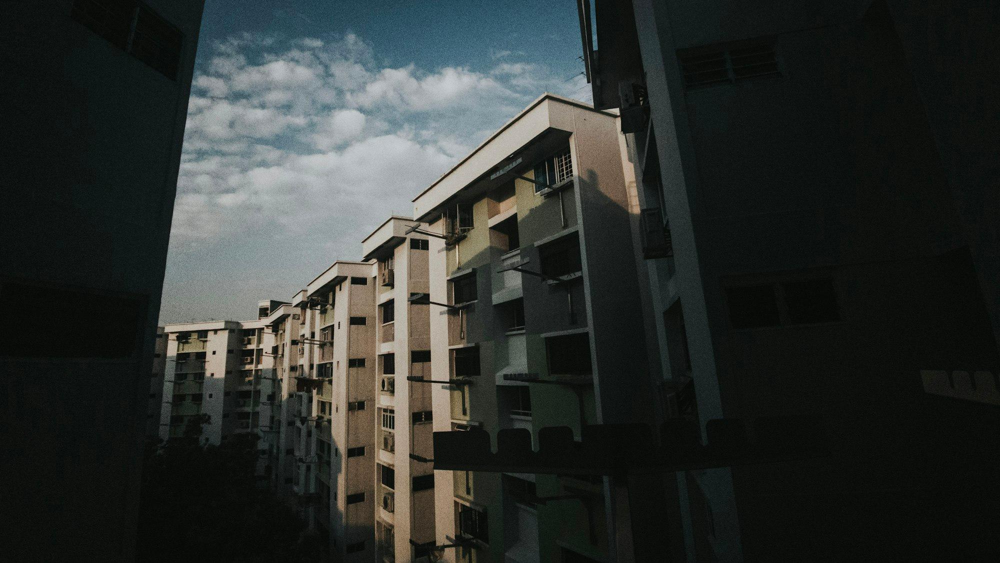 A row of residential blocks seen from a corridor in Tampines