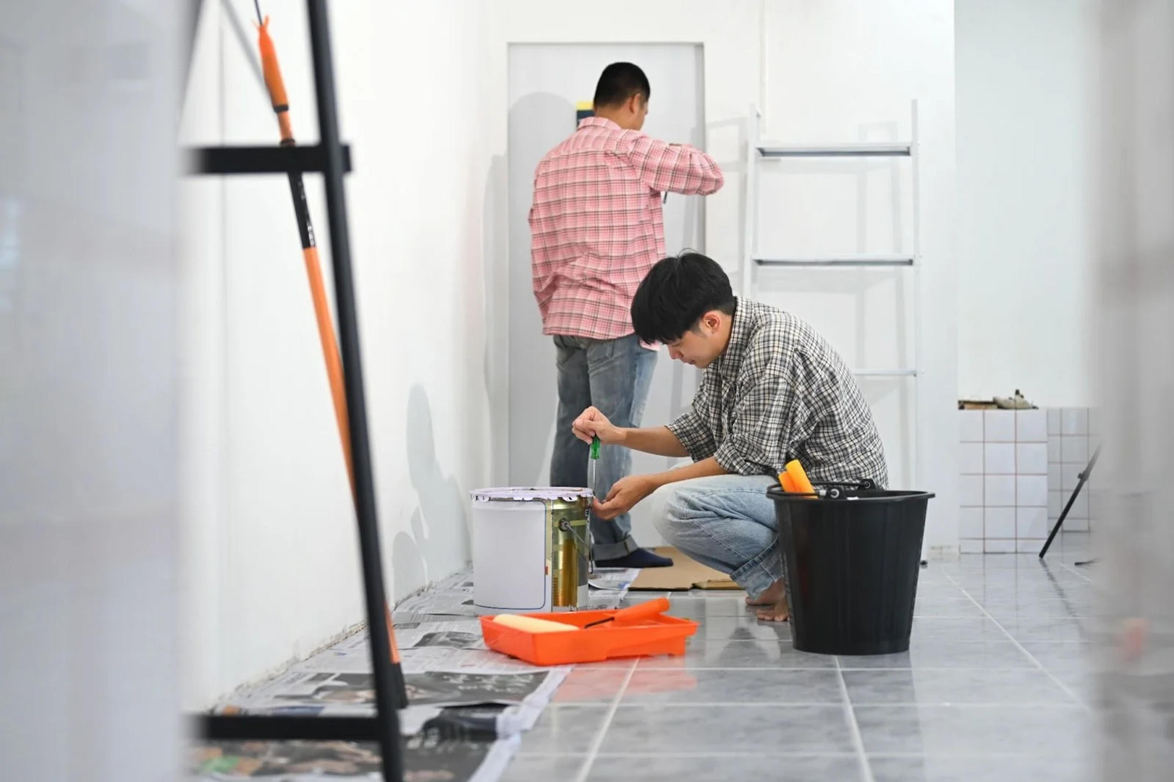 Contractors repairing and repainting a flat before it is sold