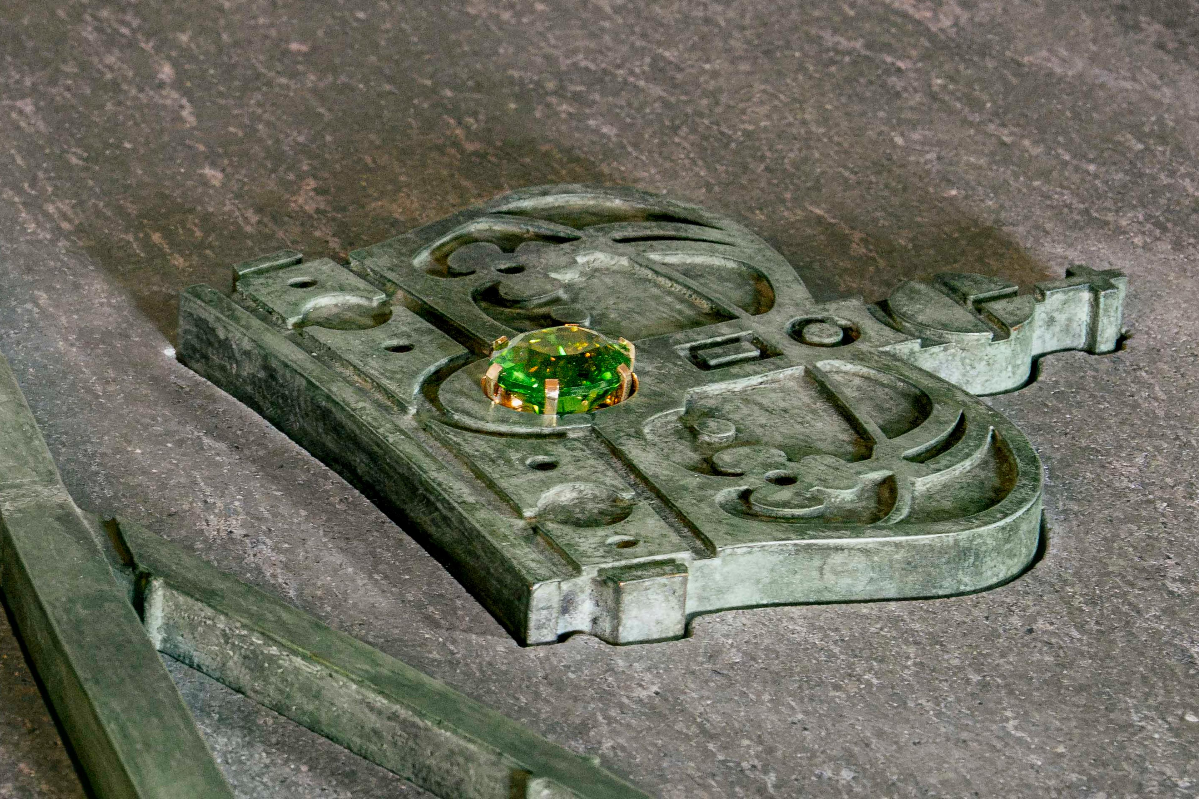 En stor, grønn peridot er plassert midt i kongekronen.