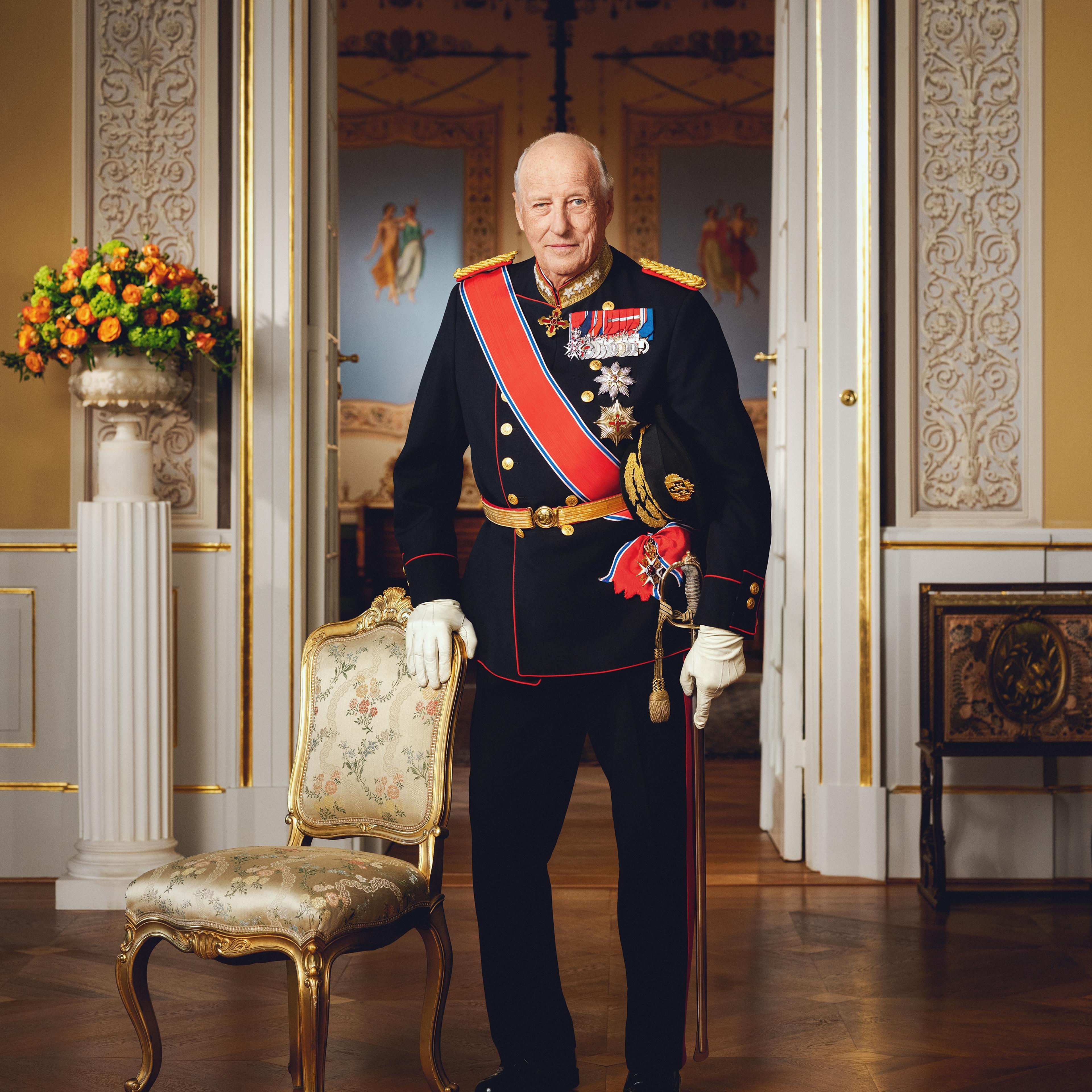 Kong Harald stående i gallauniform med ordener og medaljer.